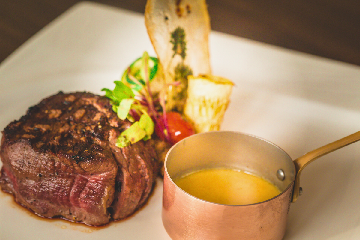 a plate of food with a copper mug