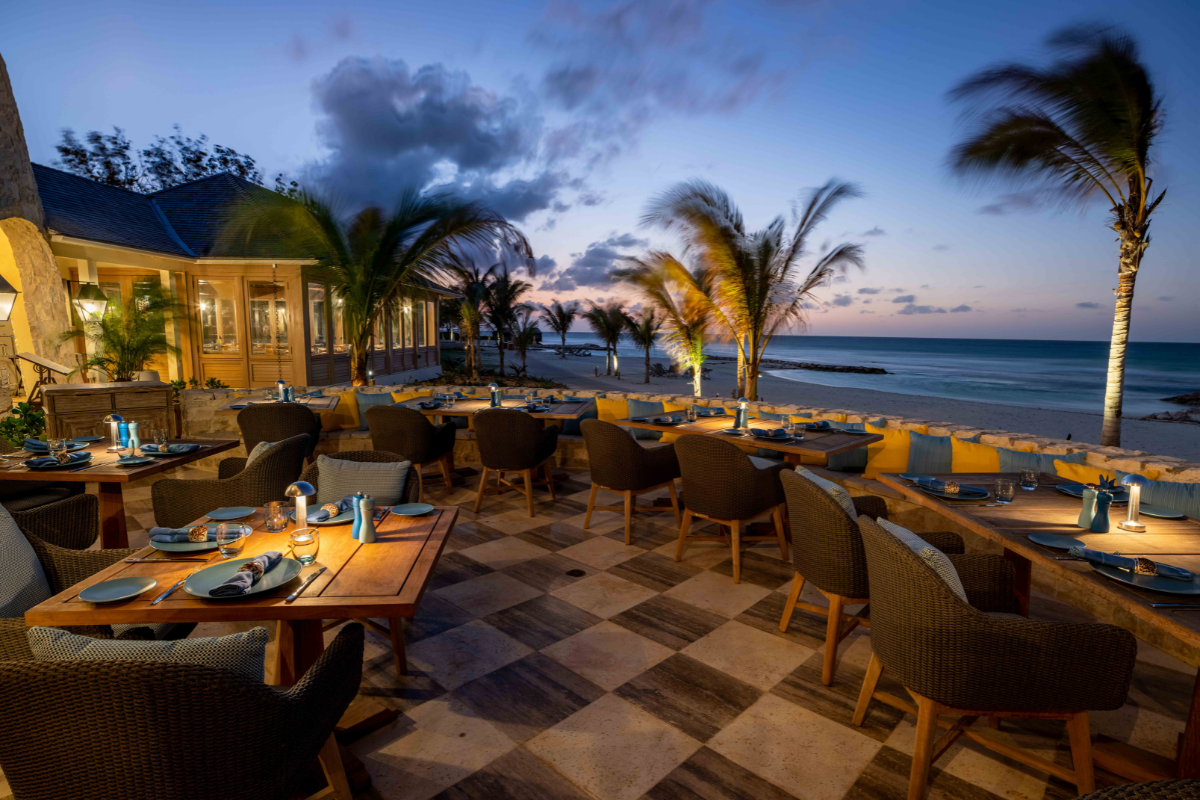 a restaurant with tables and chairs on a beach