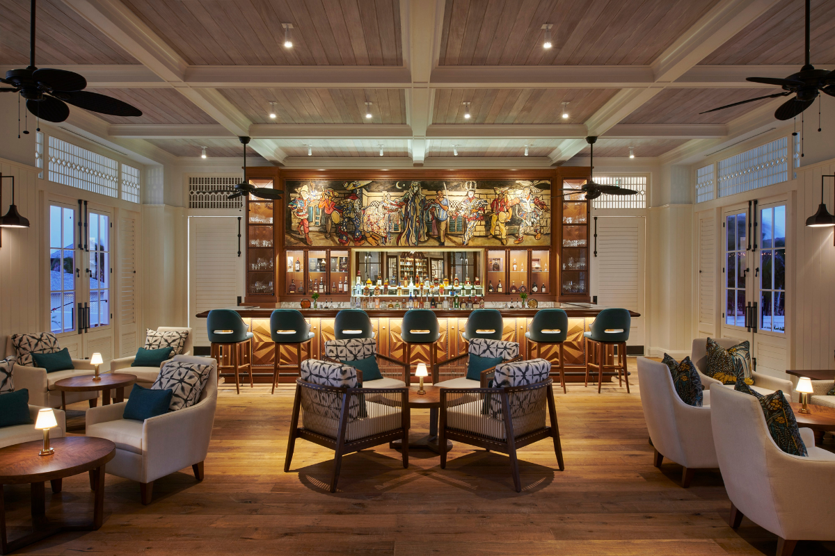a room with a bar and chairs