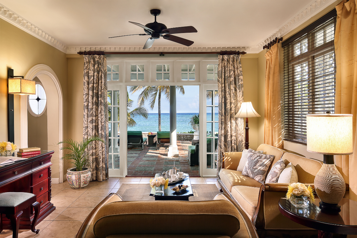 a living room with a view of the ocean from the patio