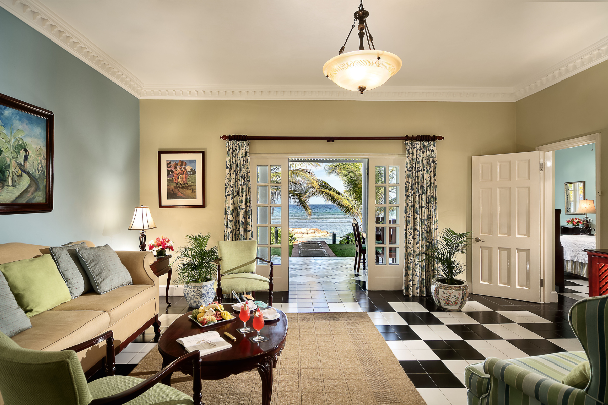 a living room with a black and white checkered floor and a couch and a table