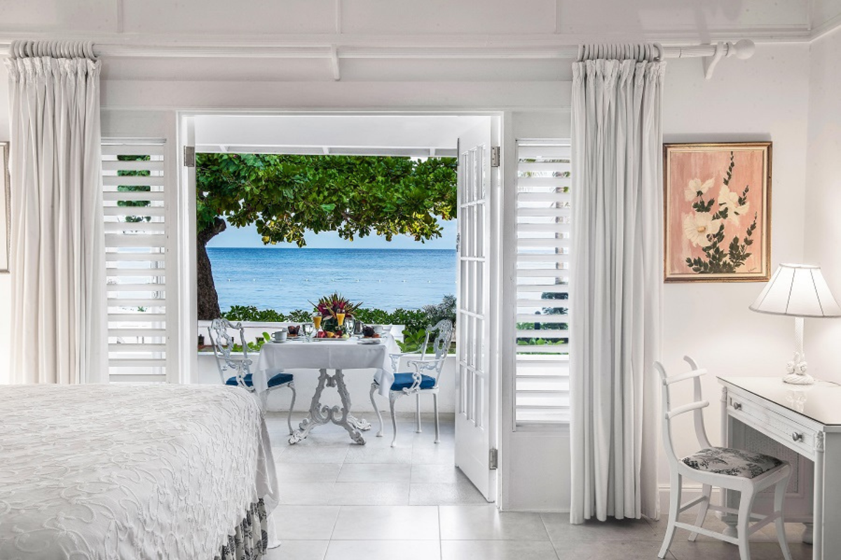 a room with a table and chairs and a bed and a table with chairs and a table with chairs