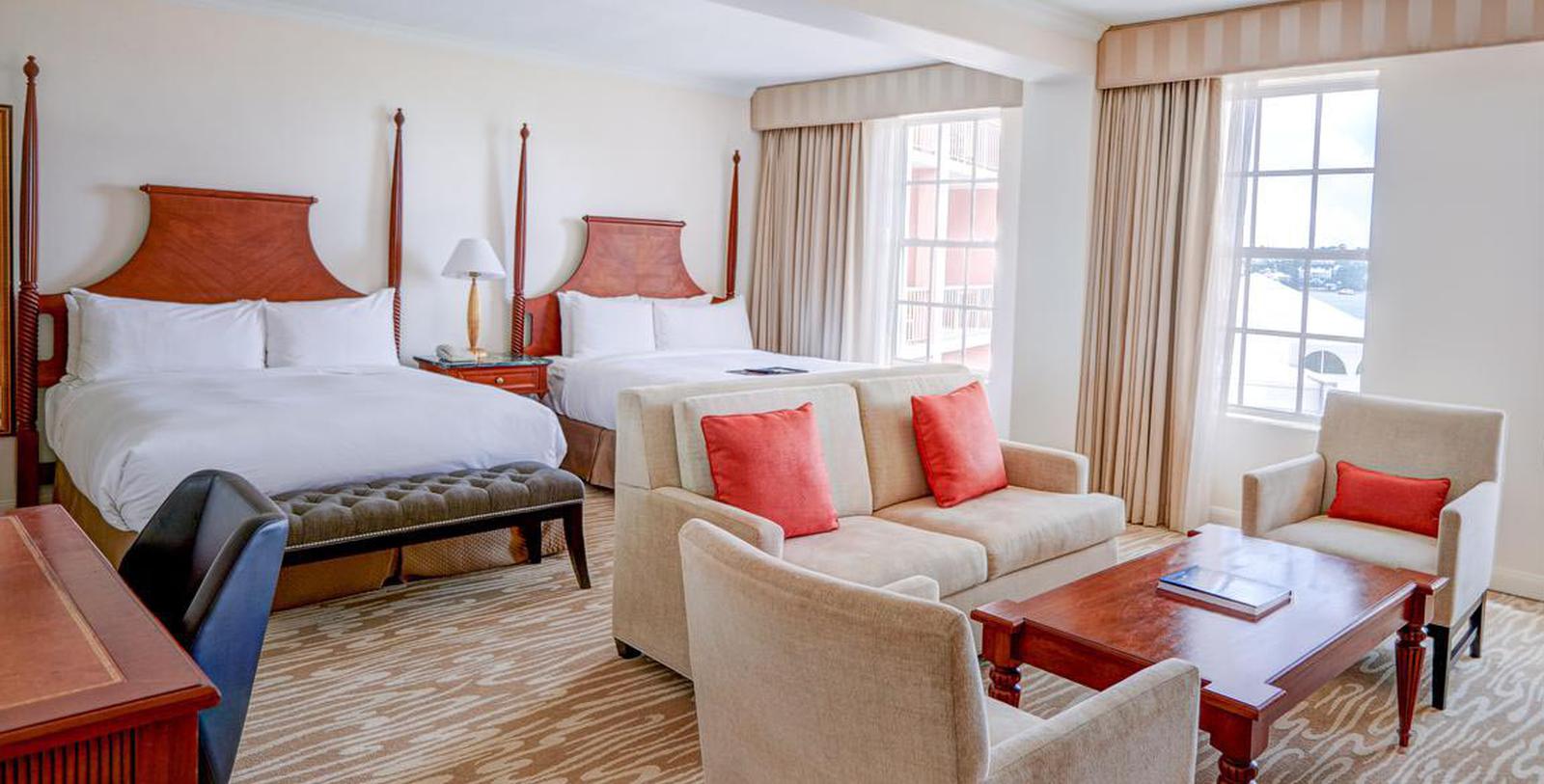 a room with two beds and a couch