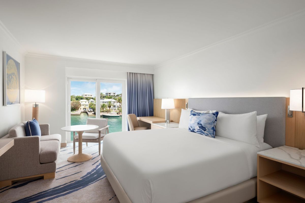 a room with a bed and a table and chairs
