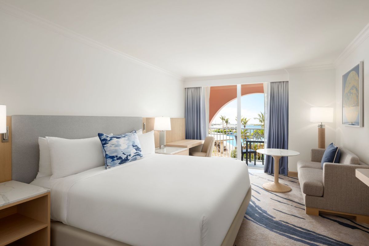 a hotel room with a bed and a table and chairs