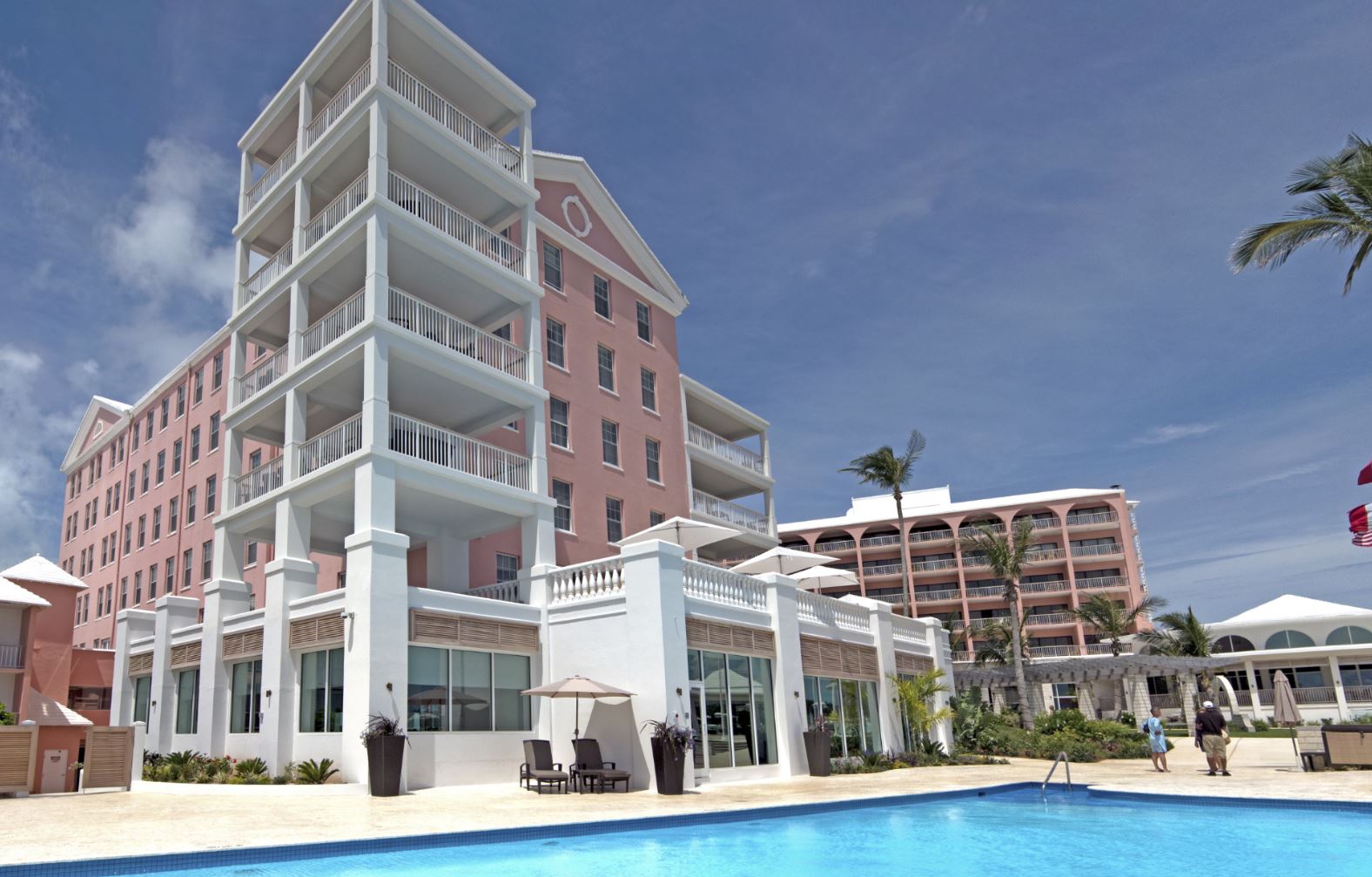 a building with a pool and a building in the background