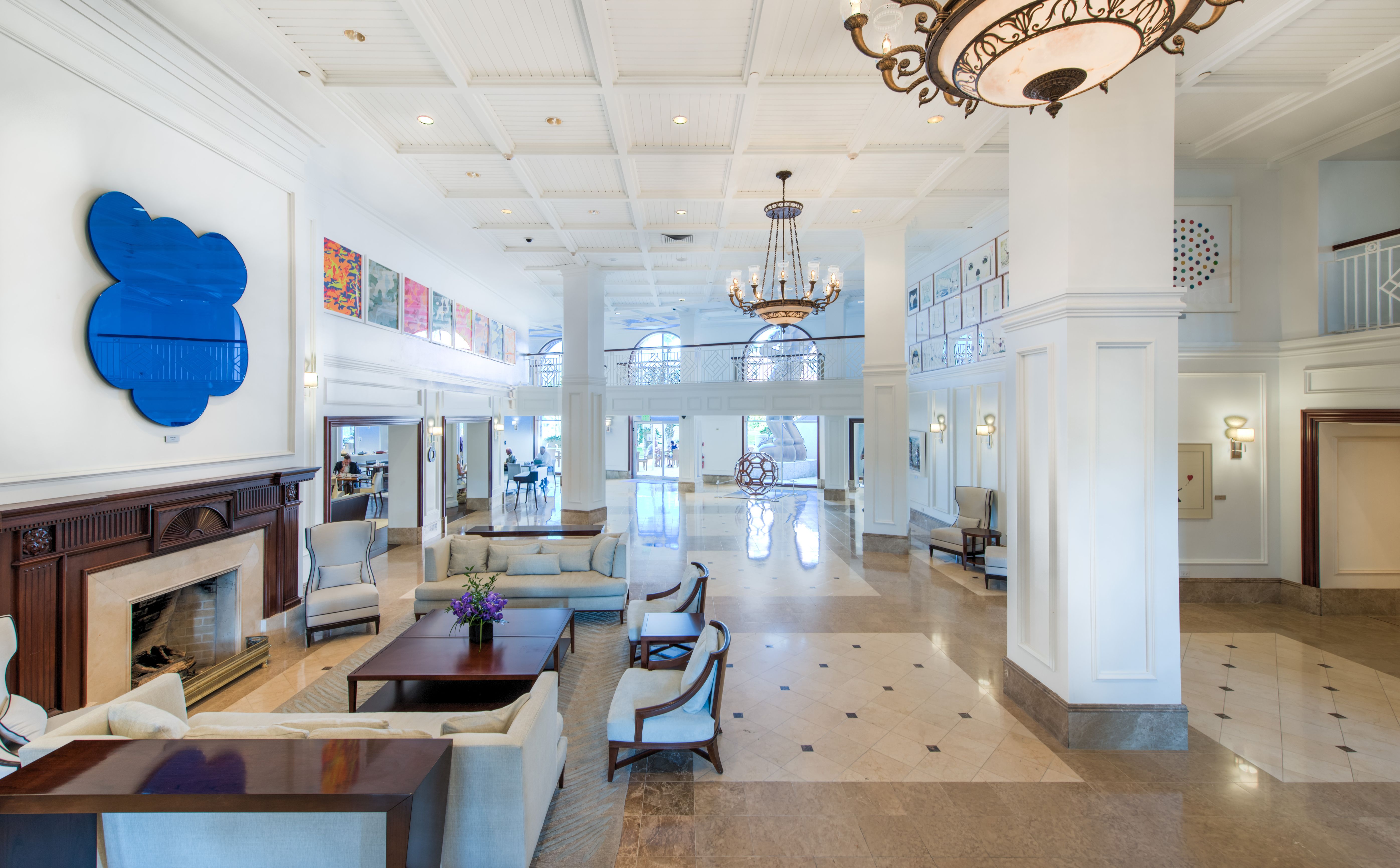 a large room with white walls and a chandelier