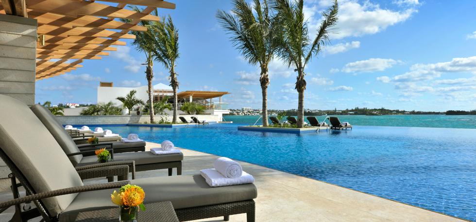 a pool with lounge chairs and palm trees