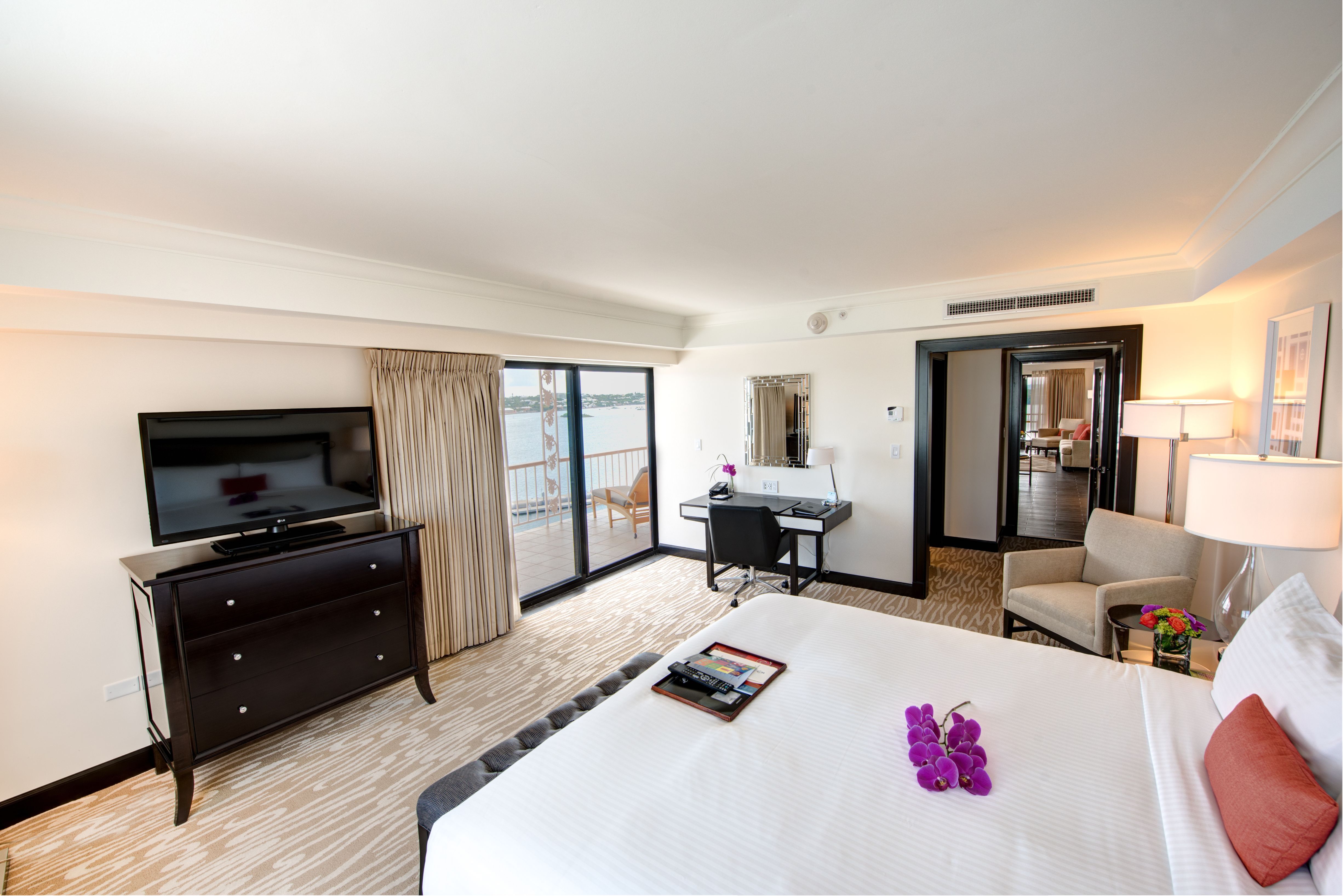 a room with a bed and a television