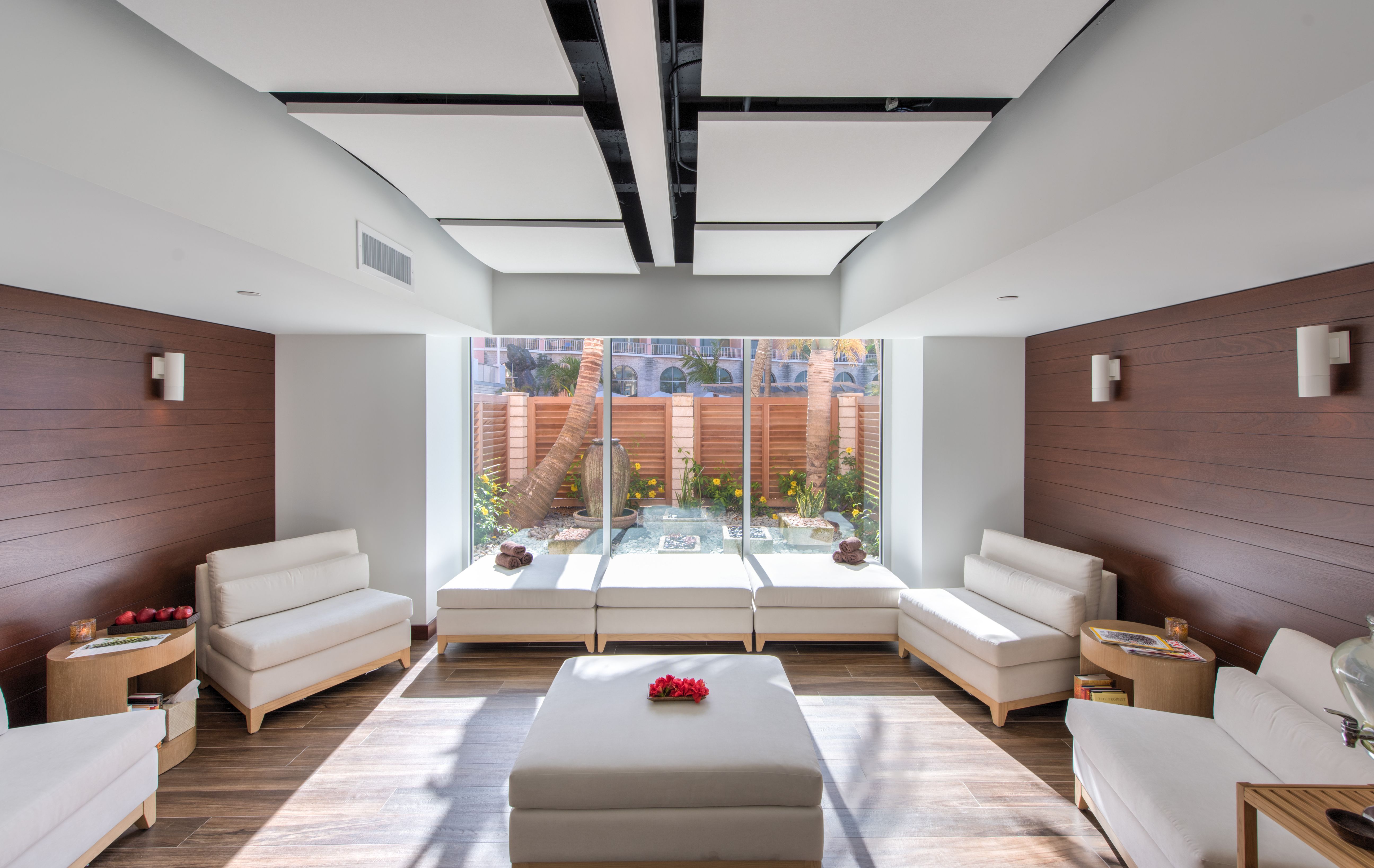 a room with white furniture and a large window
