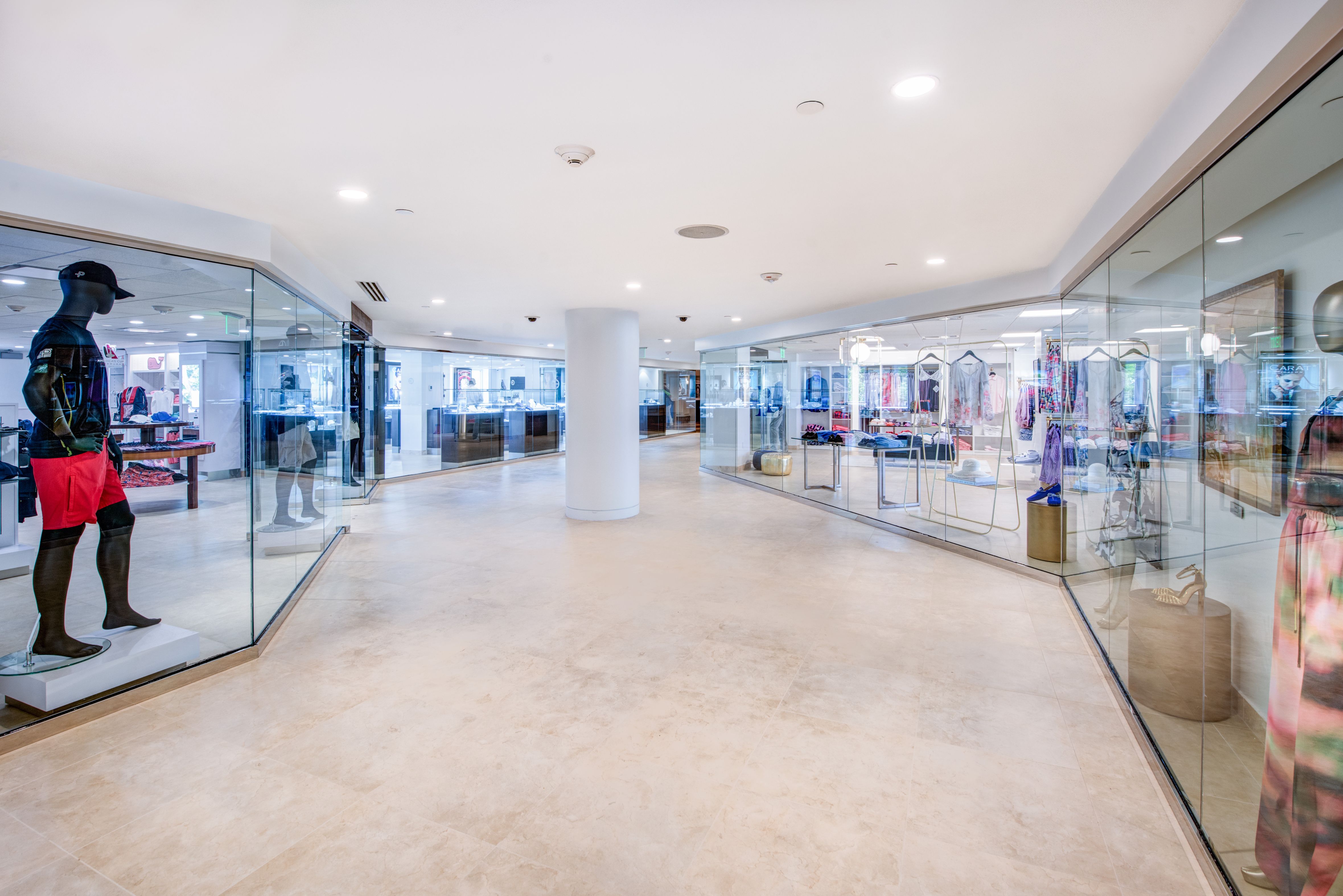 a large room with glass walls and a large white column