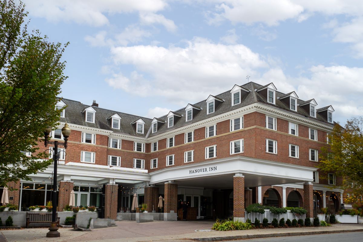 a large brick building with a white column