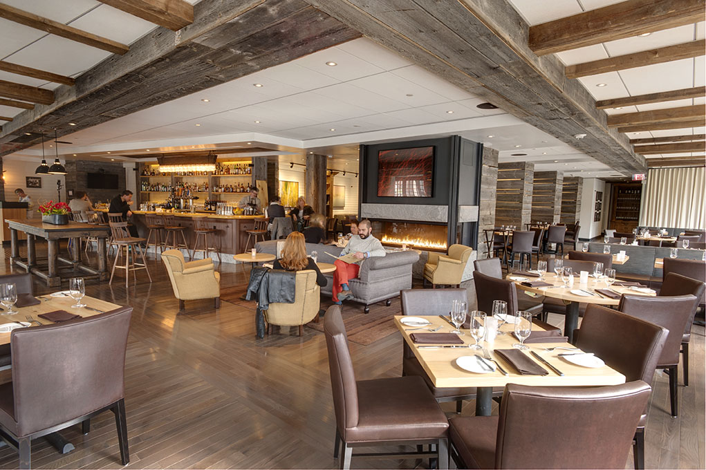 a group of people sitting at tables in a restaurant