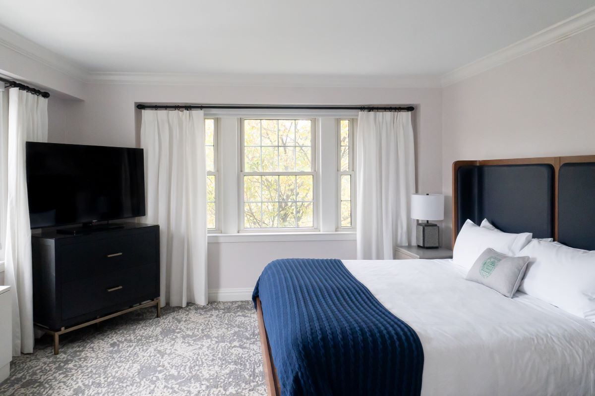 a bedroom with a bed and a tv