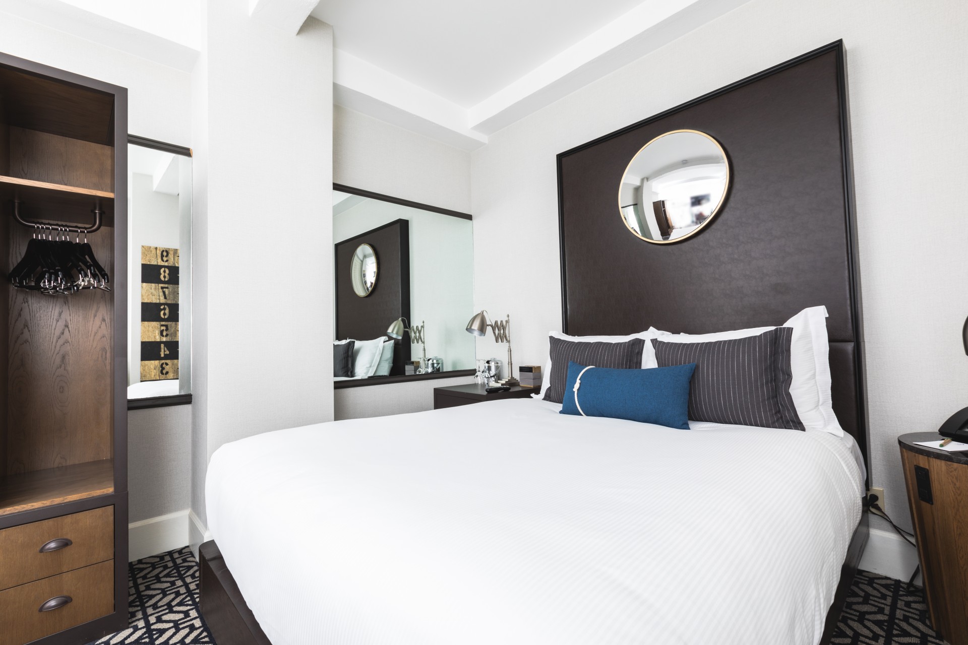 a bed with a mirror above it