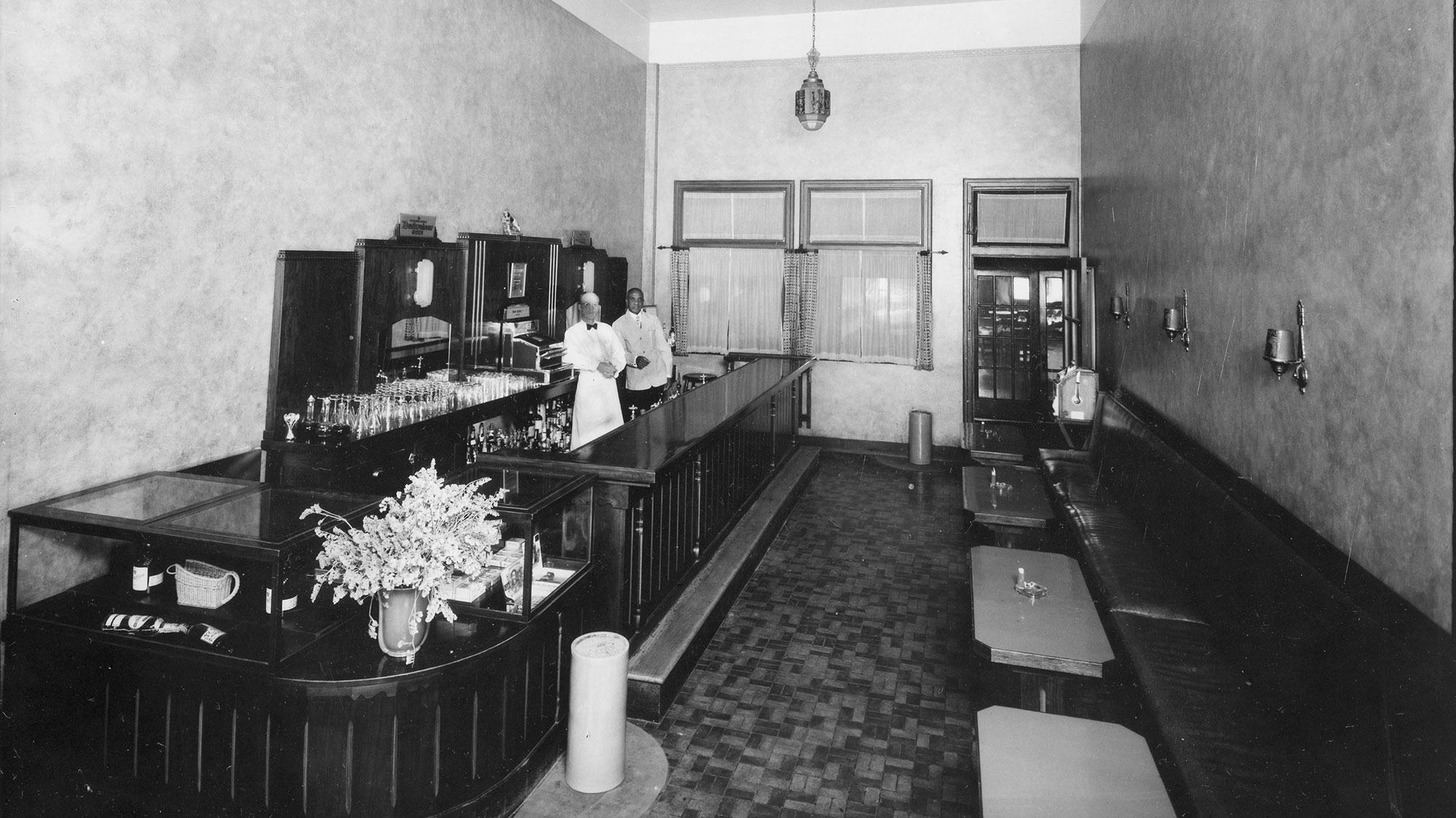 a man standing behind a bar