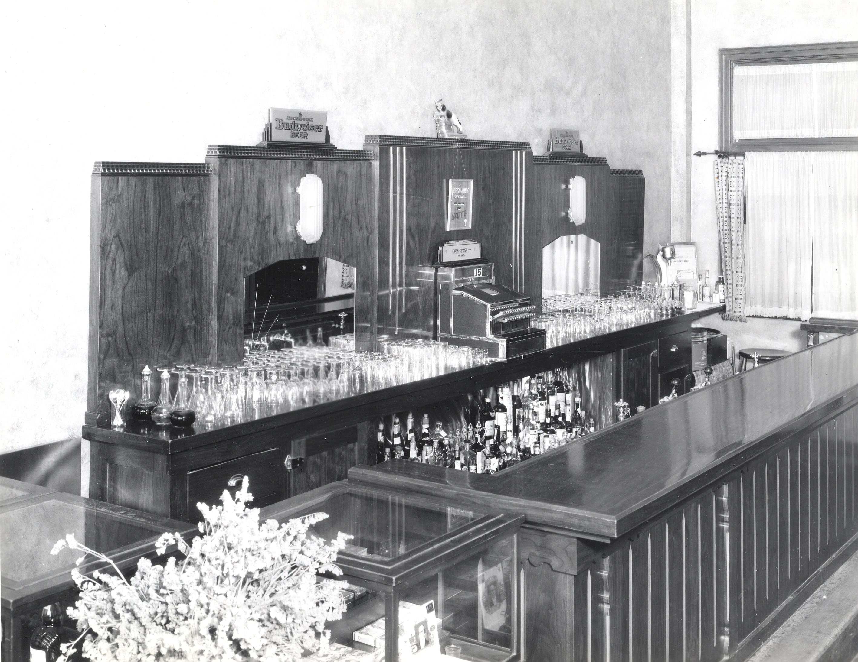 a bar with many bottles and glasses