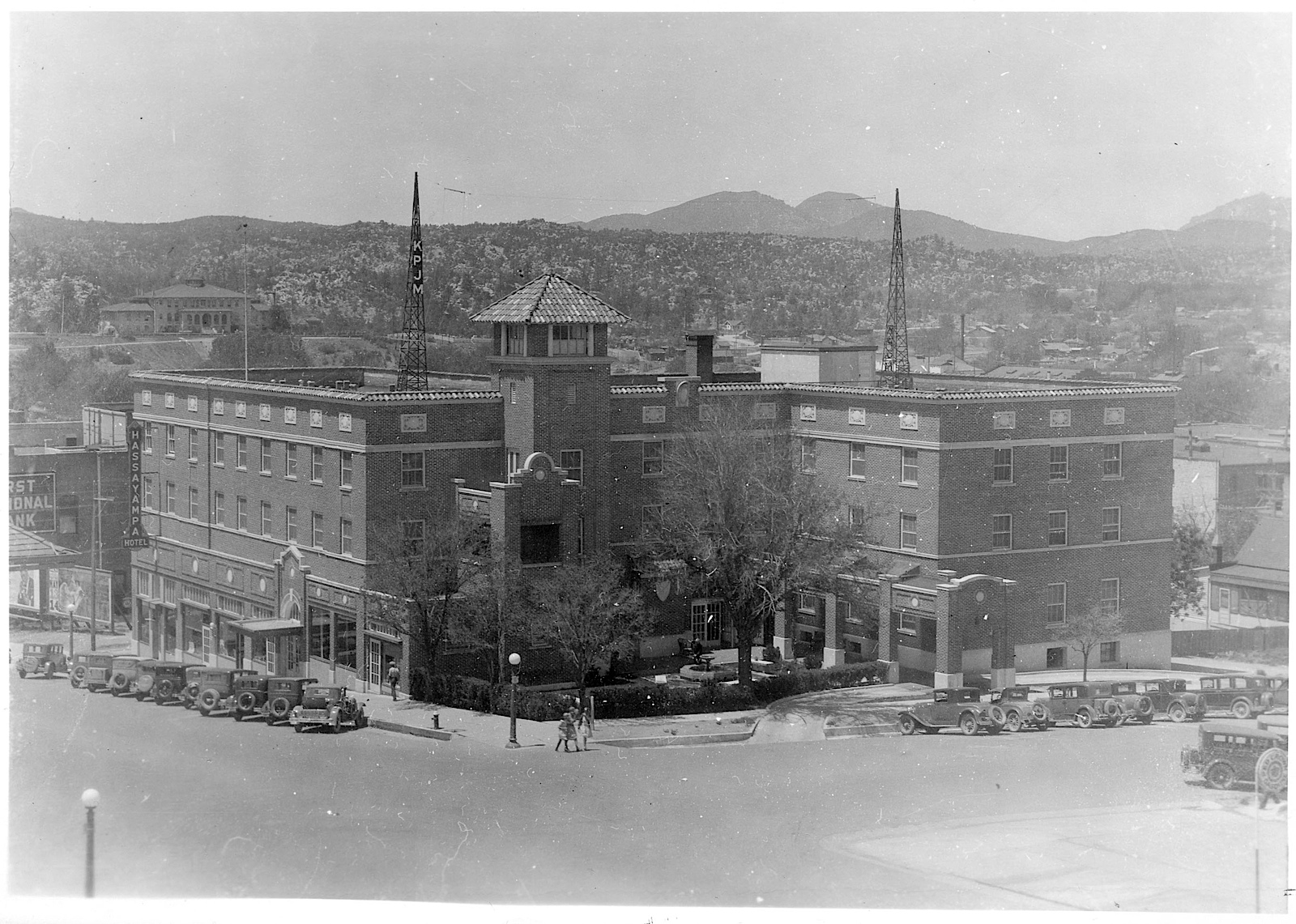 a large building with a tower and a parking lot