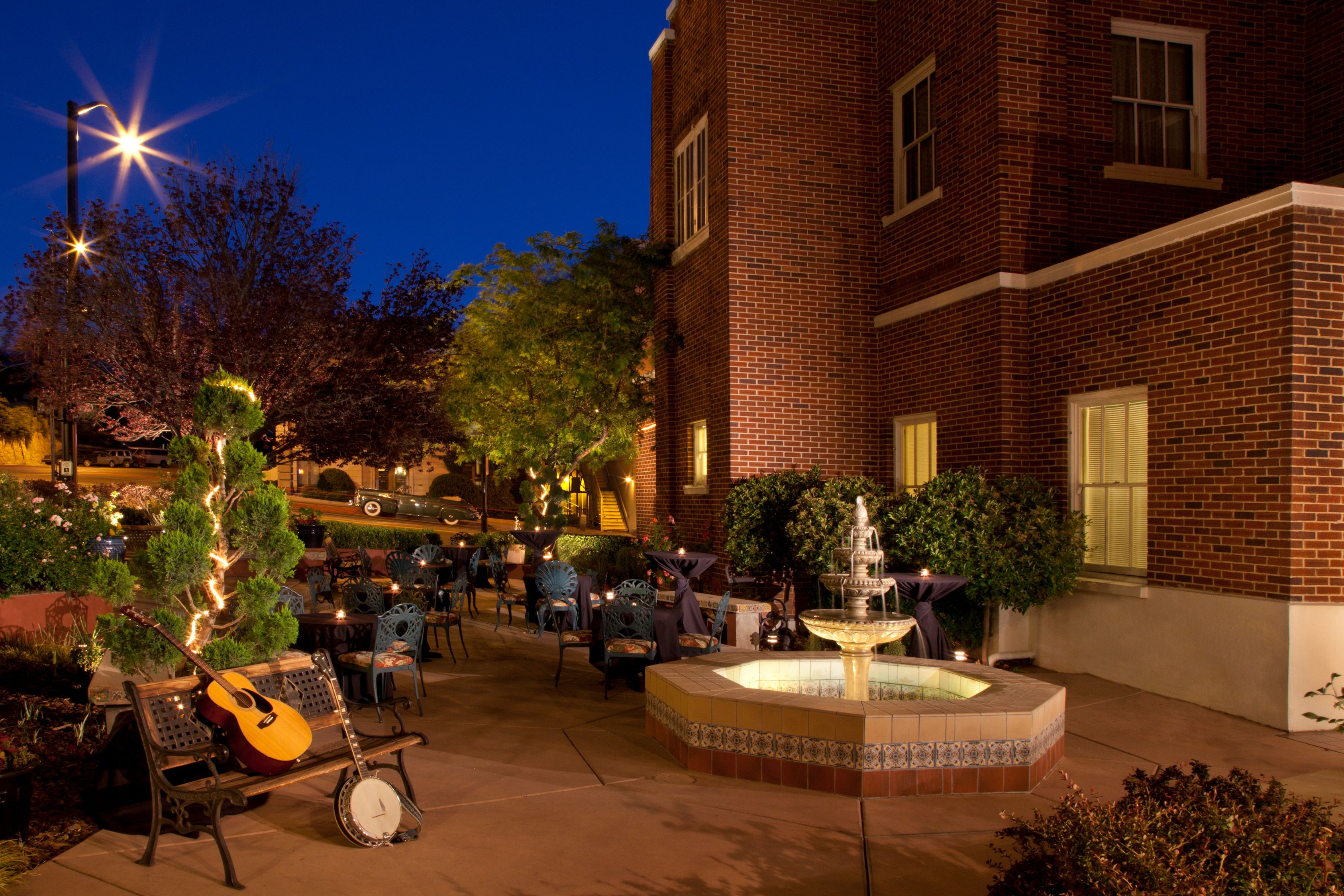 a fountain with chairs and a guitar in the middle of it