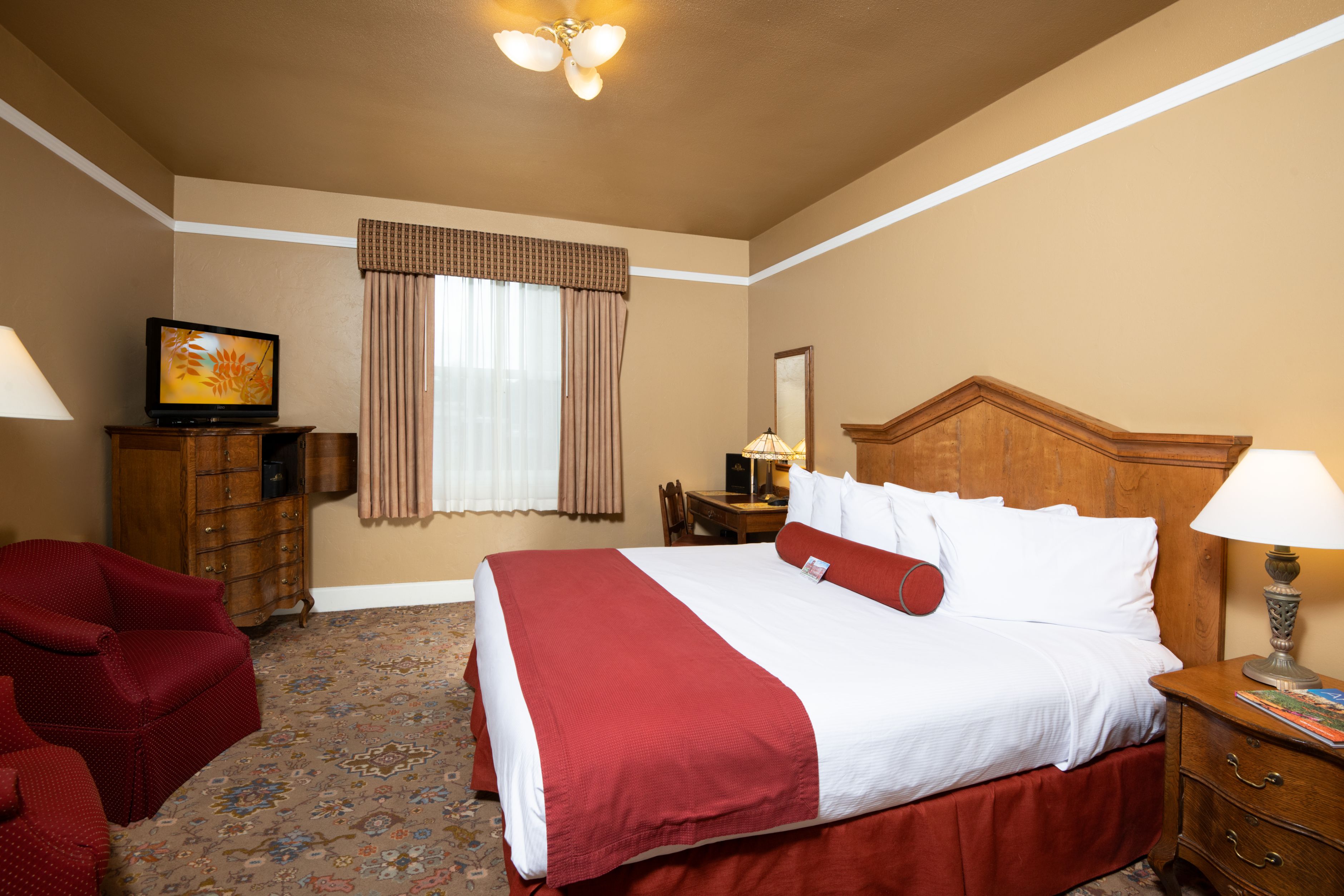 a room with a bed and a television