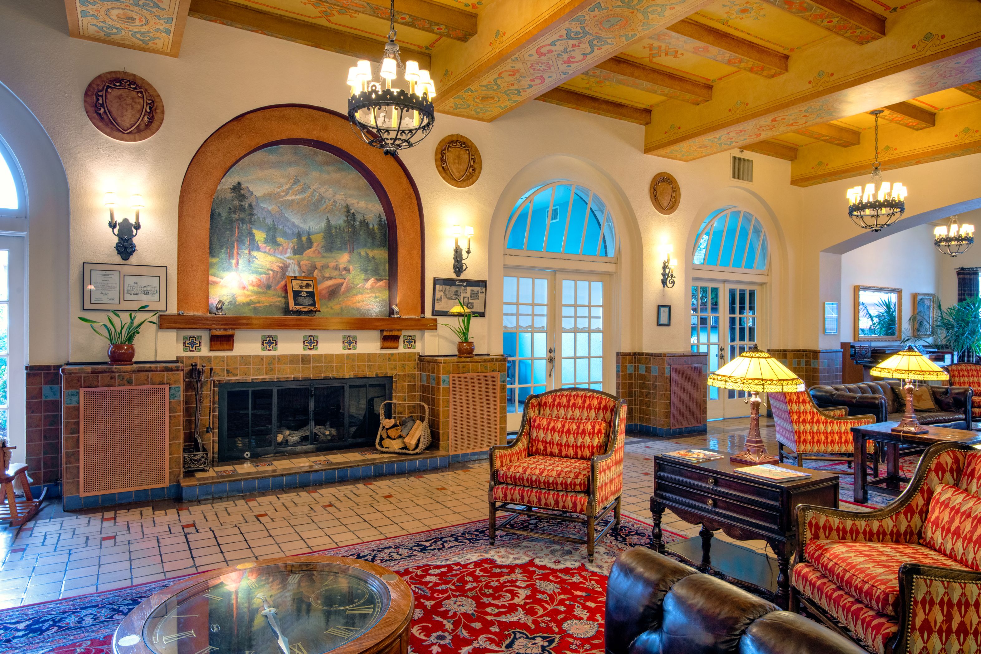 a room with a fireplace and chairs