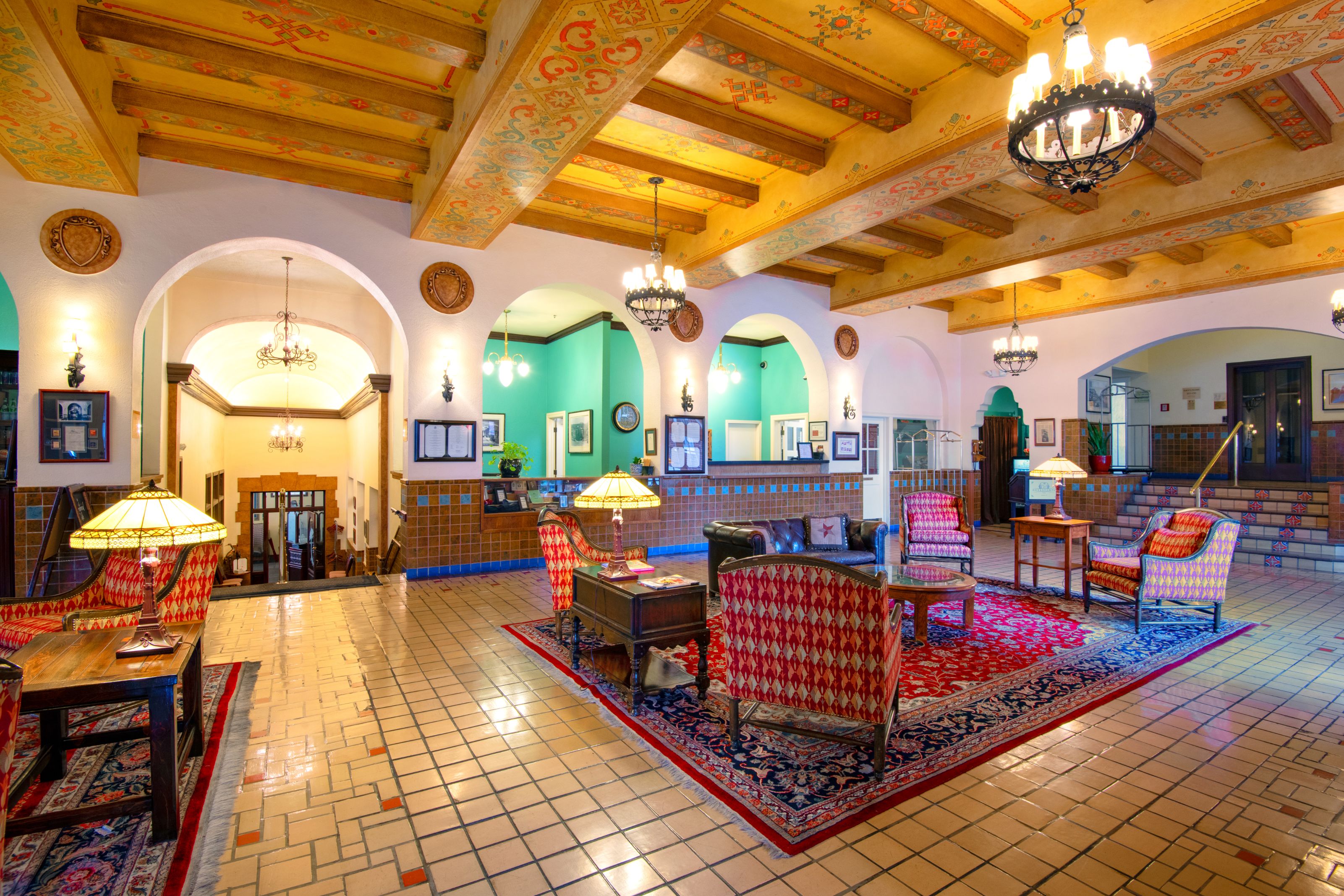a room with a large rug and chairs