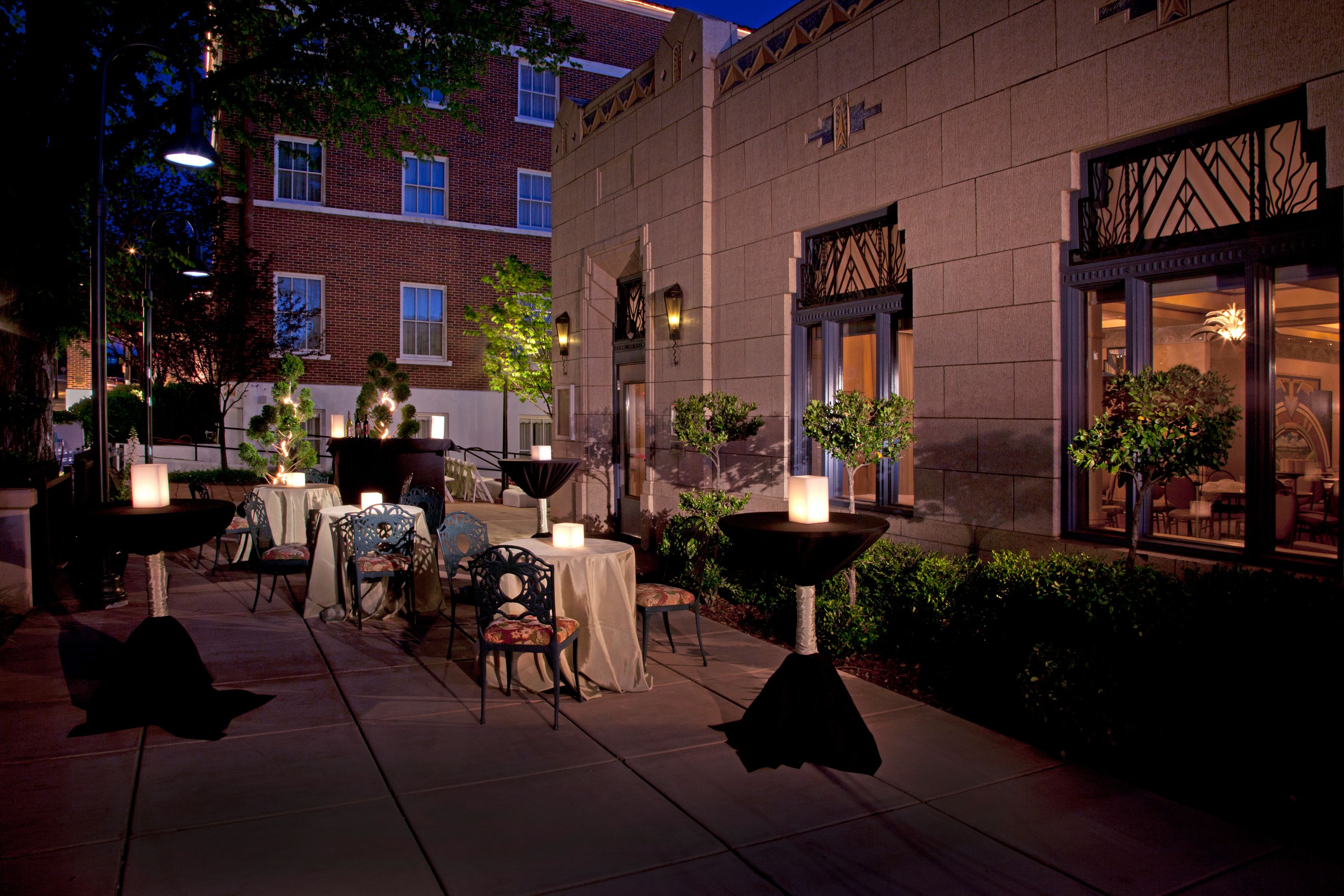 a group of tables and chairs outside of a building