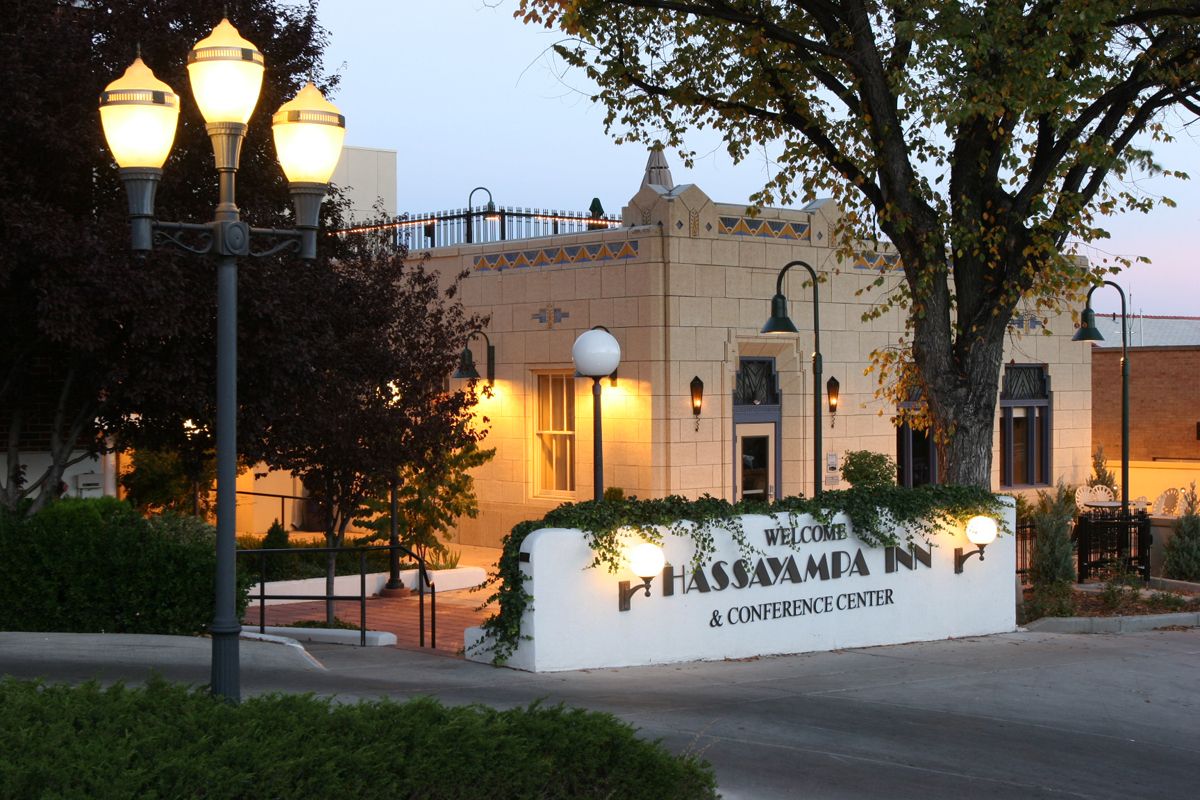 a building with a sign and street lights