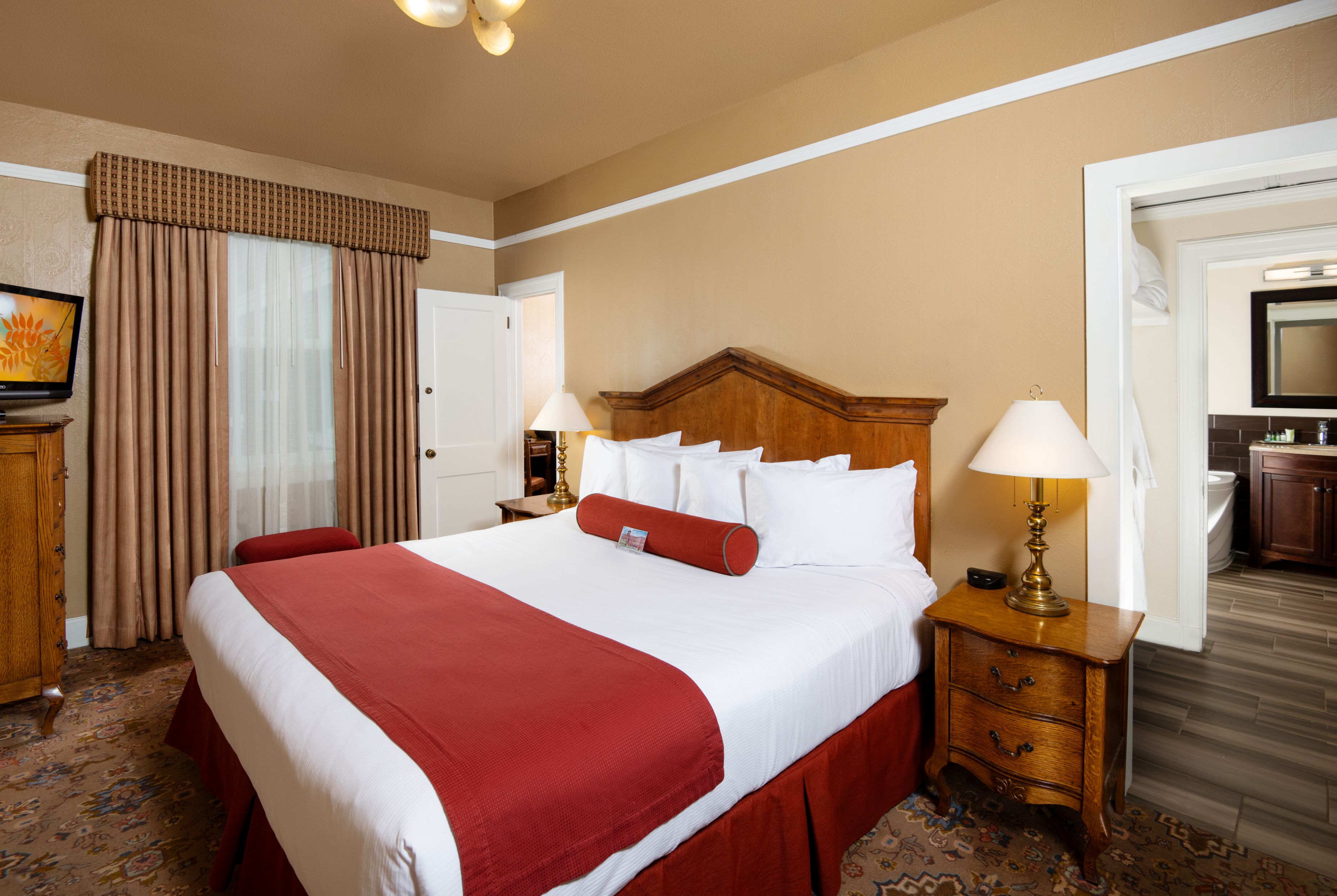 a bed with a red and white blanket