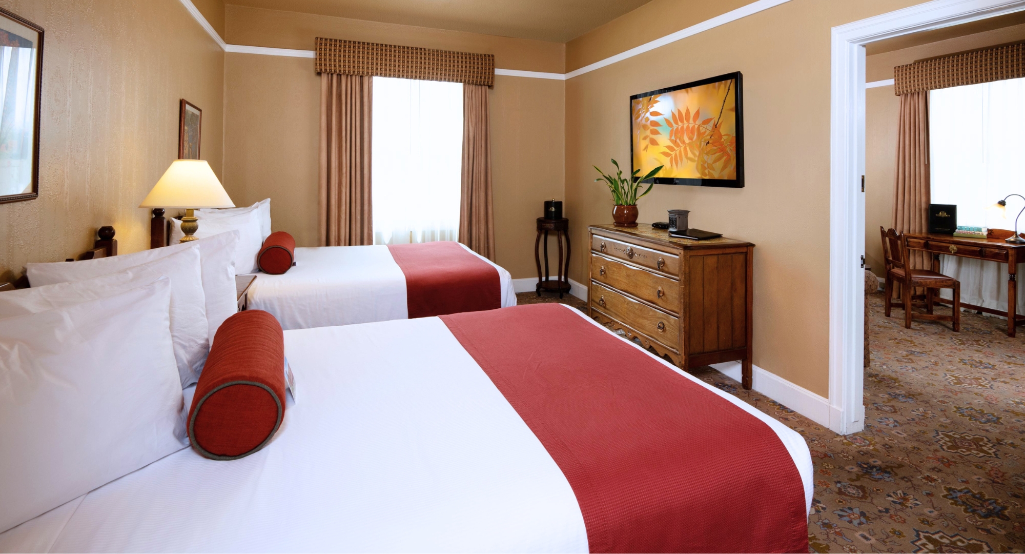 a room with two beds and a tv