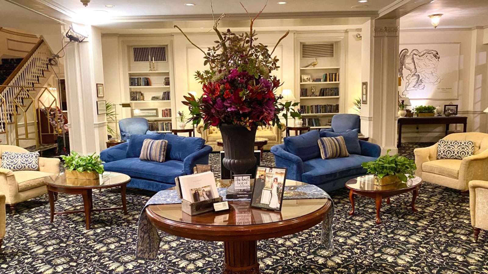 a room with a table and chairs and a vase of flowers