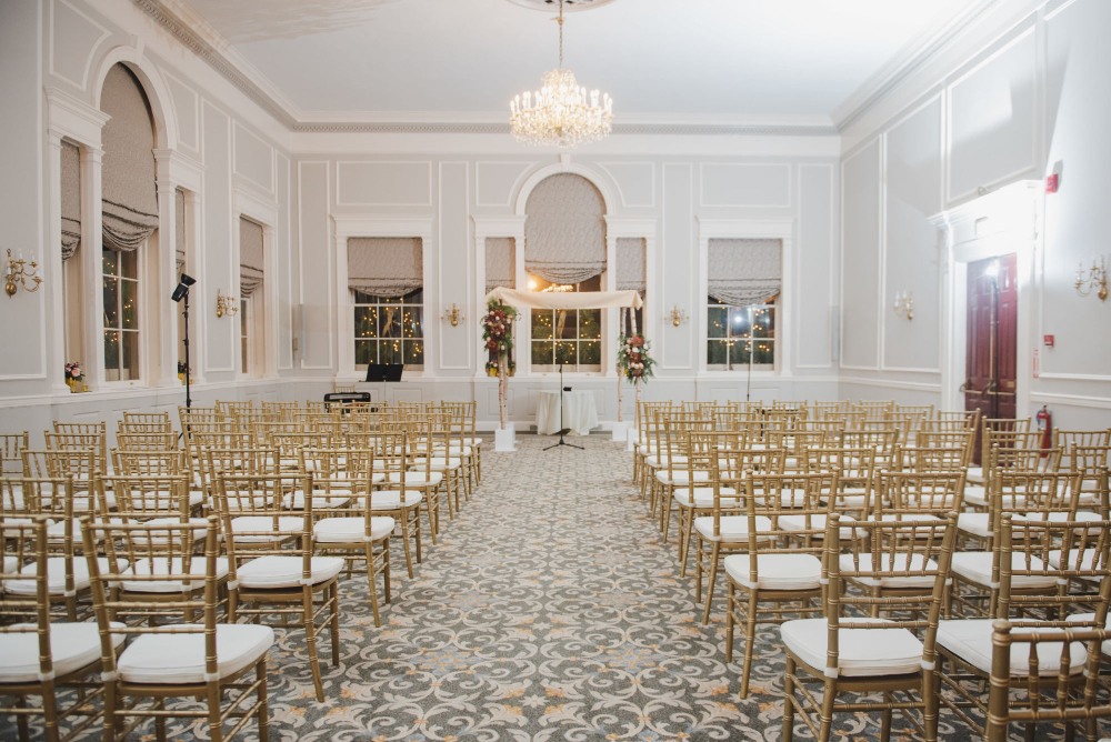 a room with chairs and a chandelier