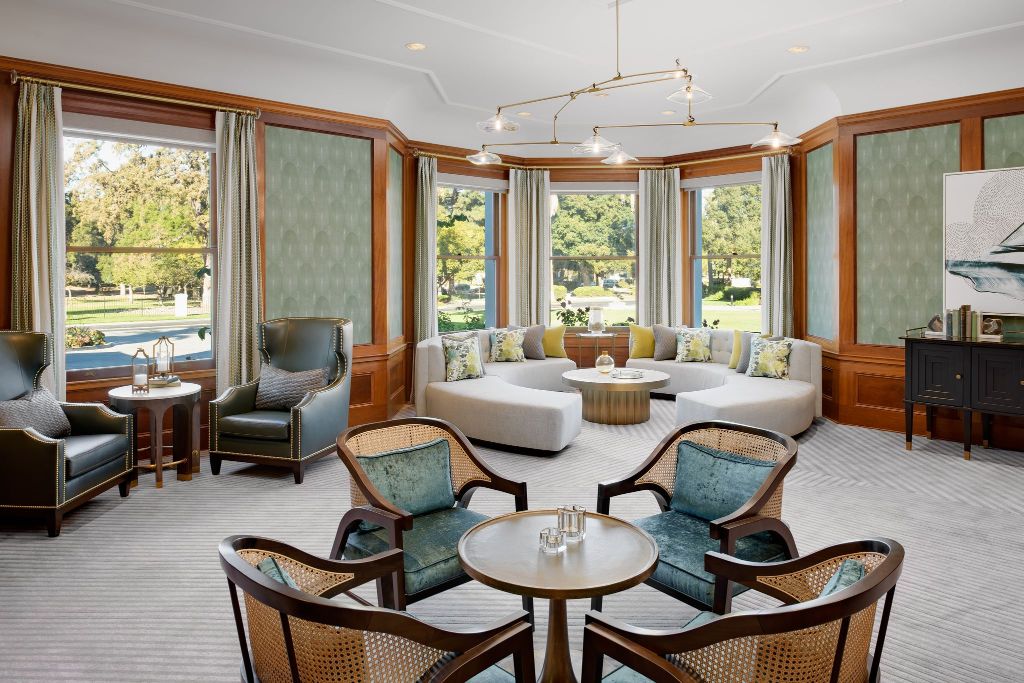 a room with a couch and chairs