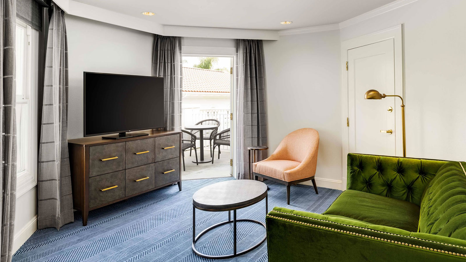 a living room with a television and a green couch