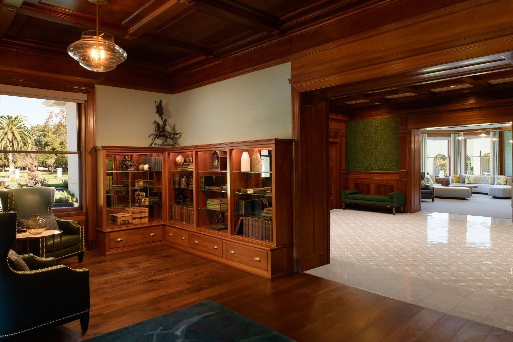 a room with a wood paneled ceiling and a glass cabinet
