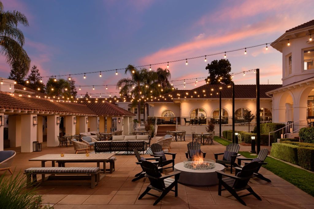 a patio with chairs and a fire pit