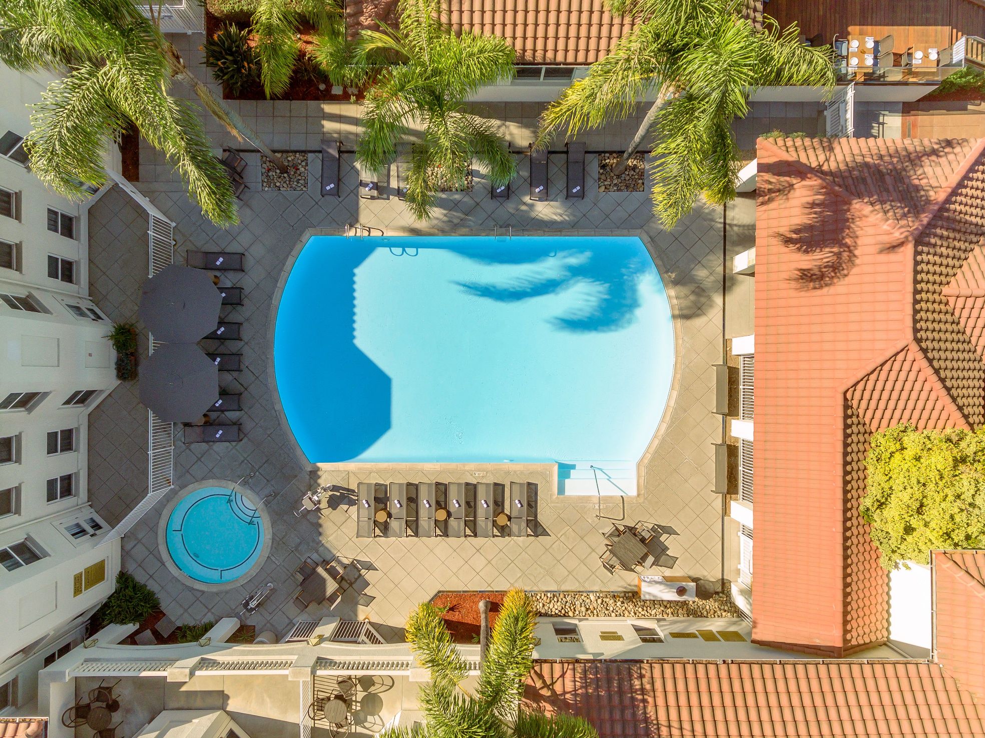a swimming pool with chairs and a hot tub