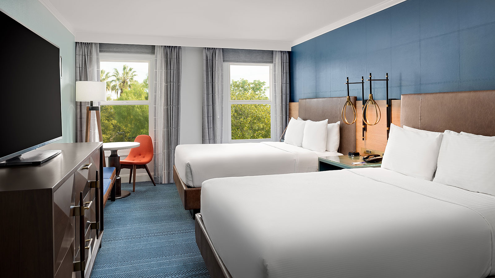 a room with two beds and a table