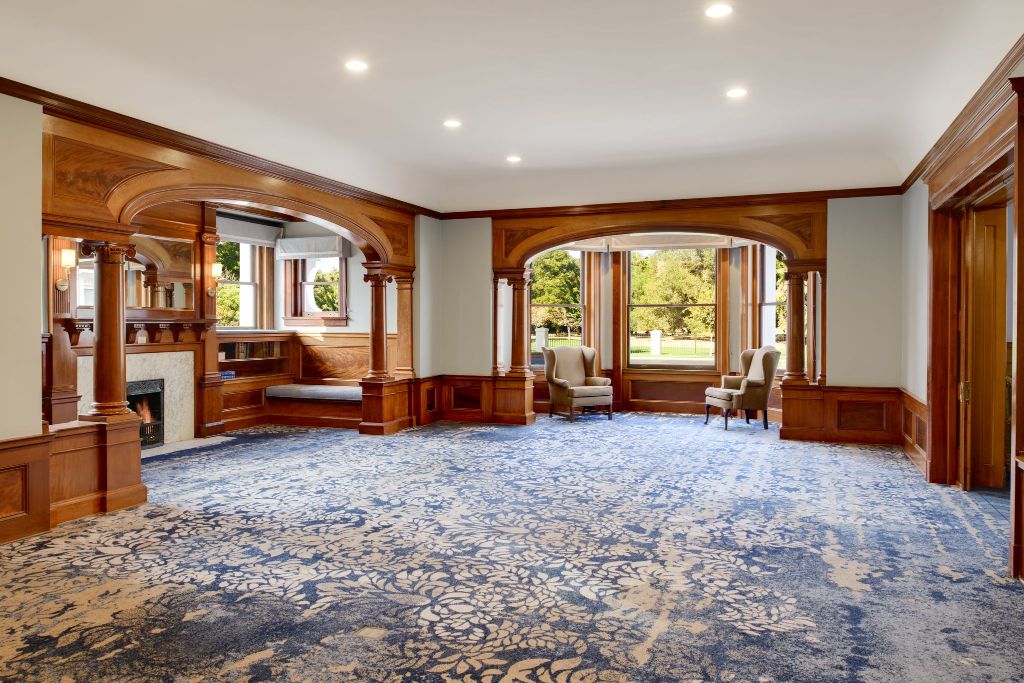 a room with a blue carpet and wood trim