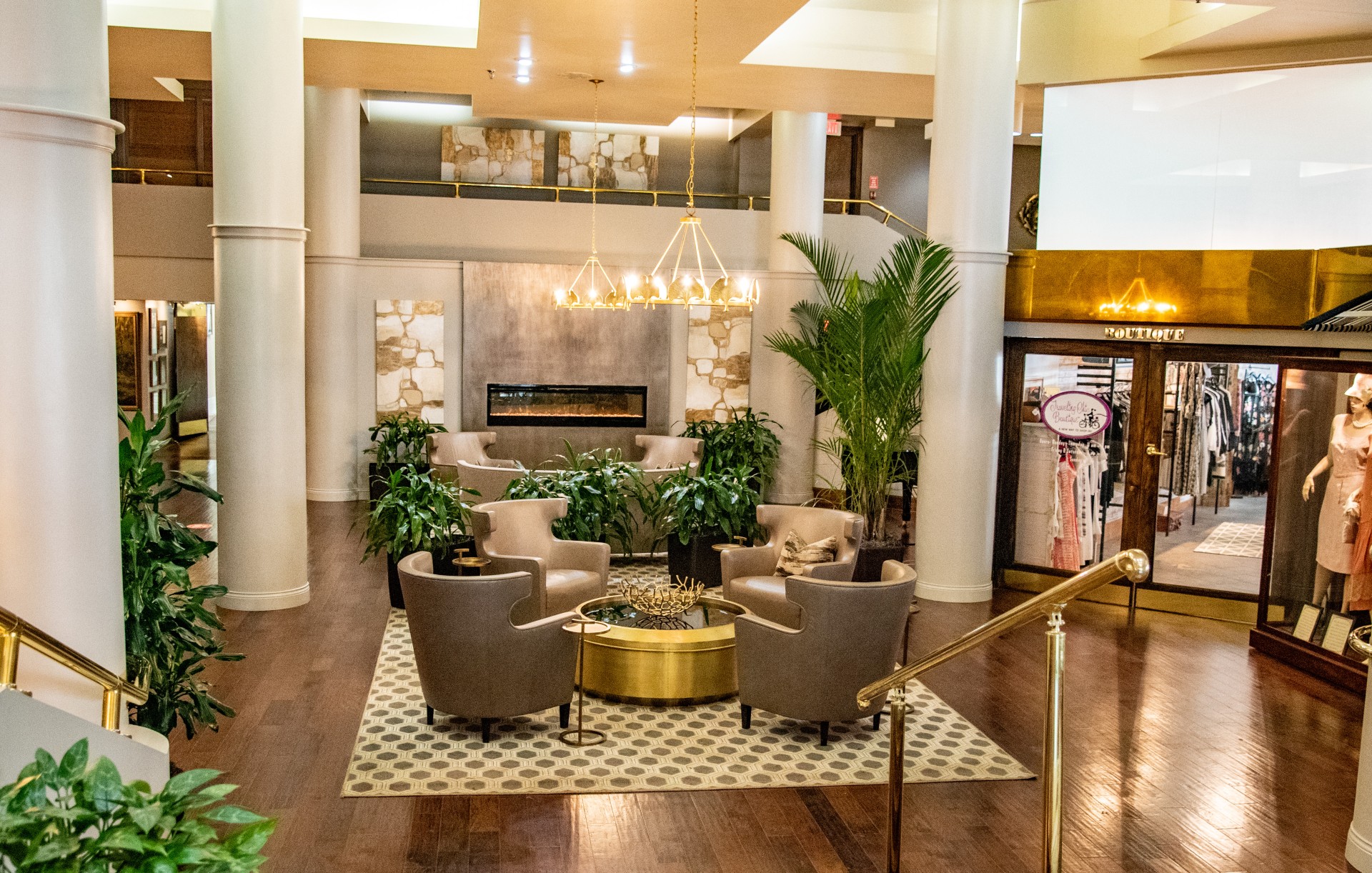 a lobby with chairs and a fireplace