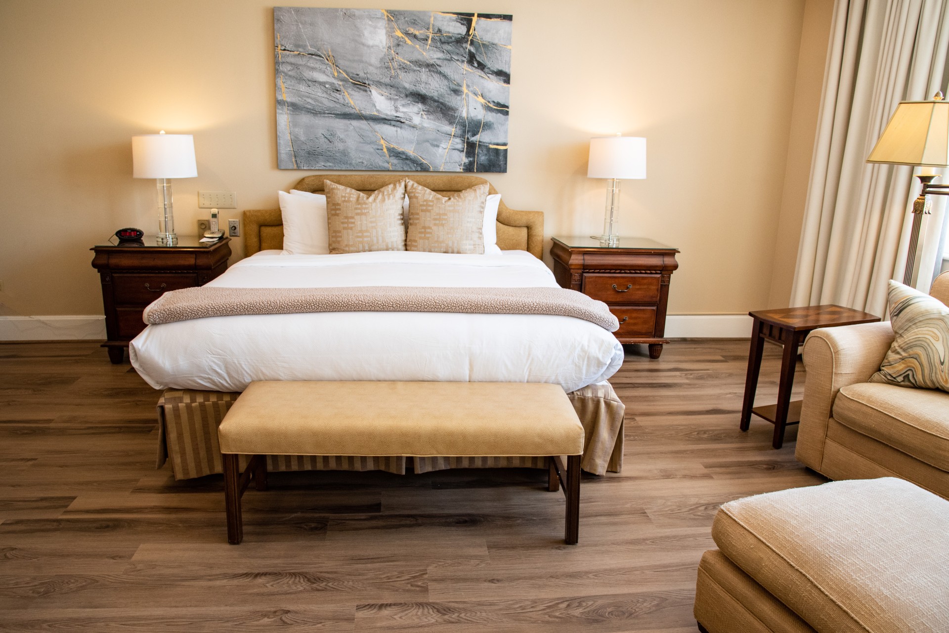 a bedroom with a bed and a painting on the wall