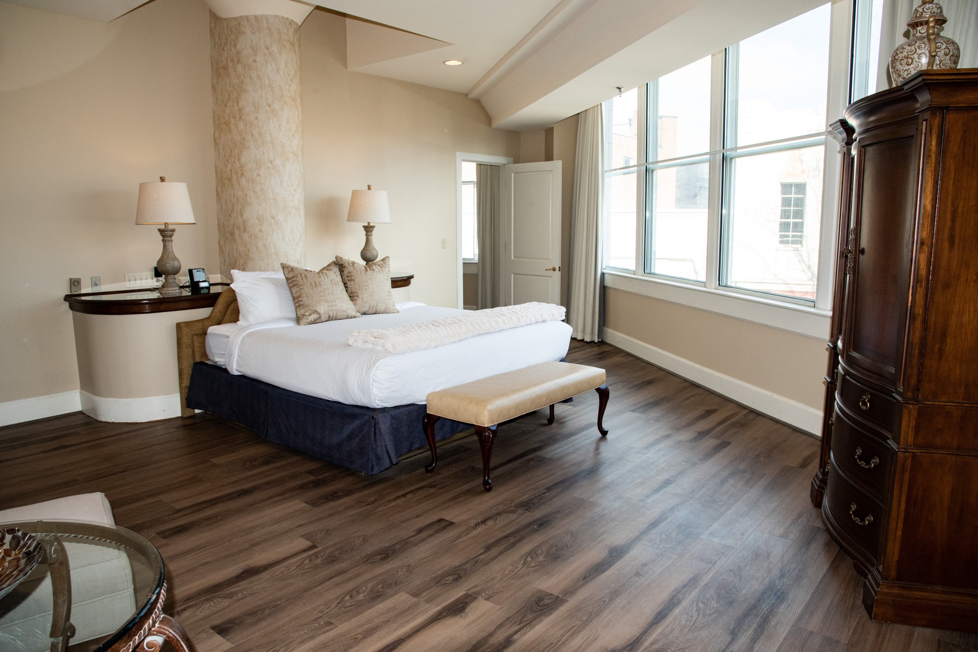 a bedroom with a large bed and a bench
