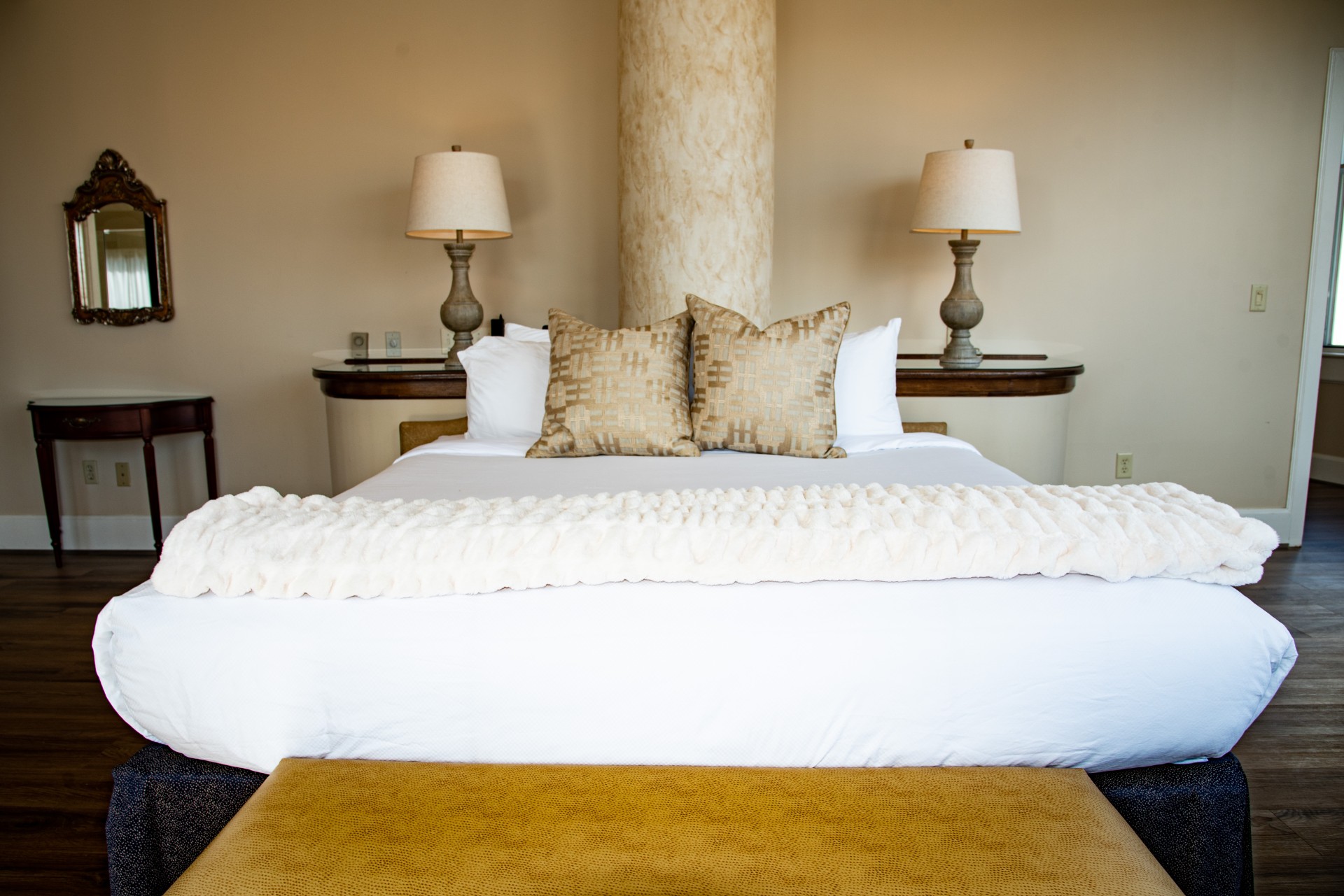 a bed with pillows and lamps