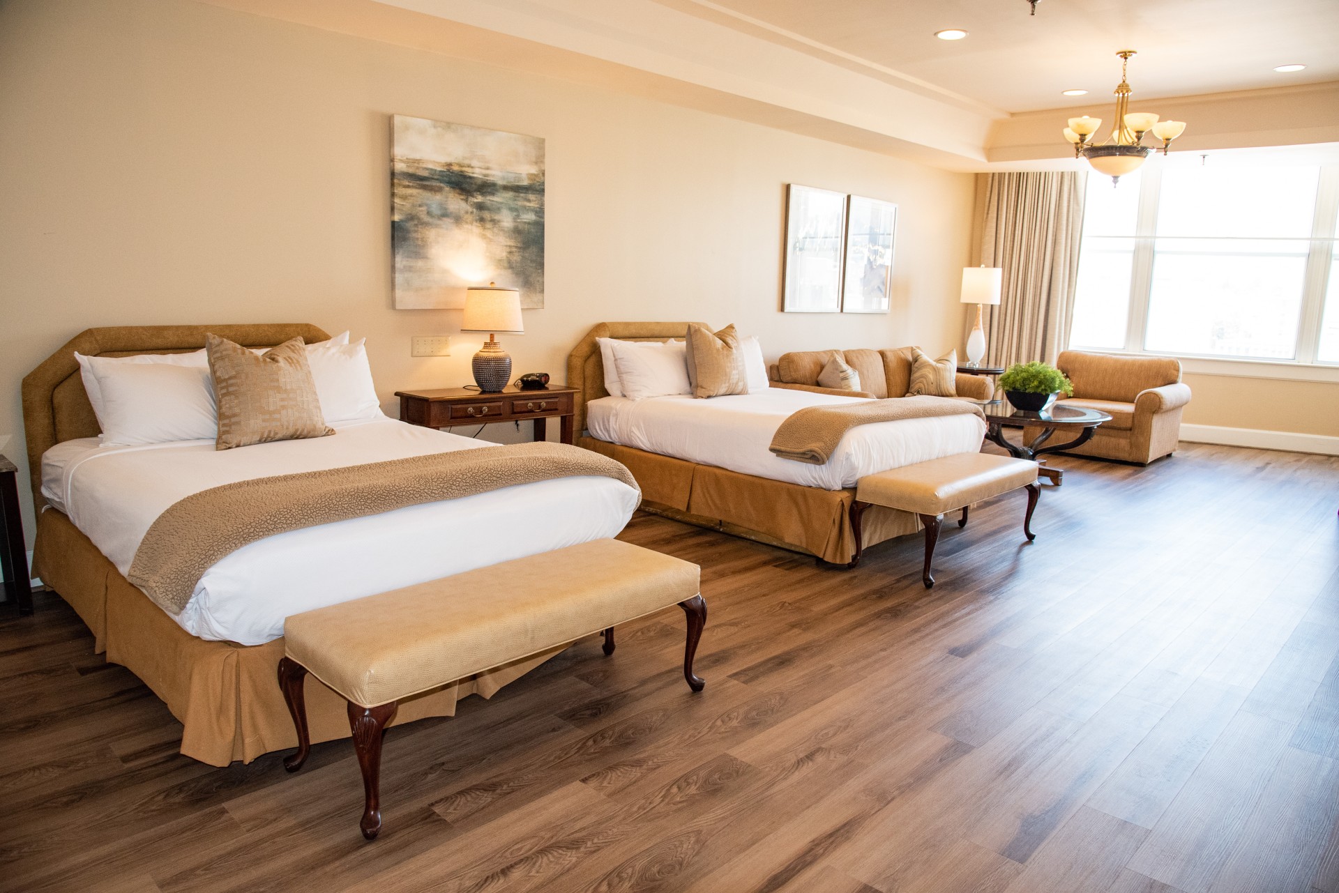 a room with two beds and a chandelier