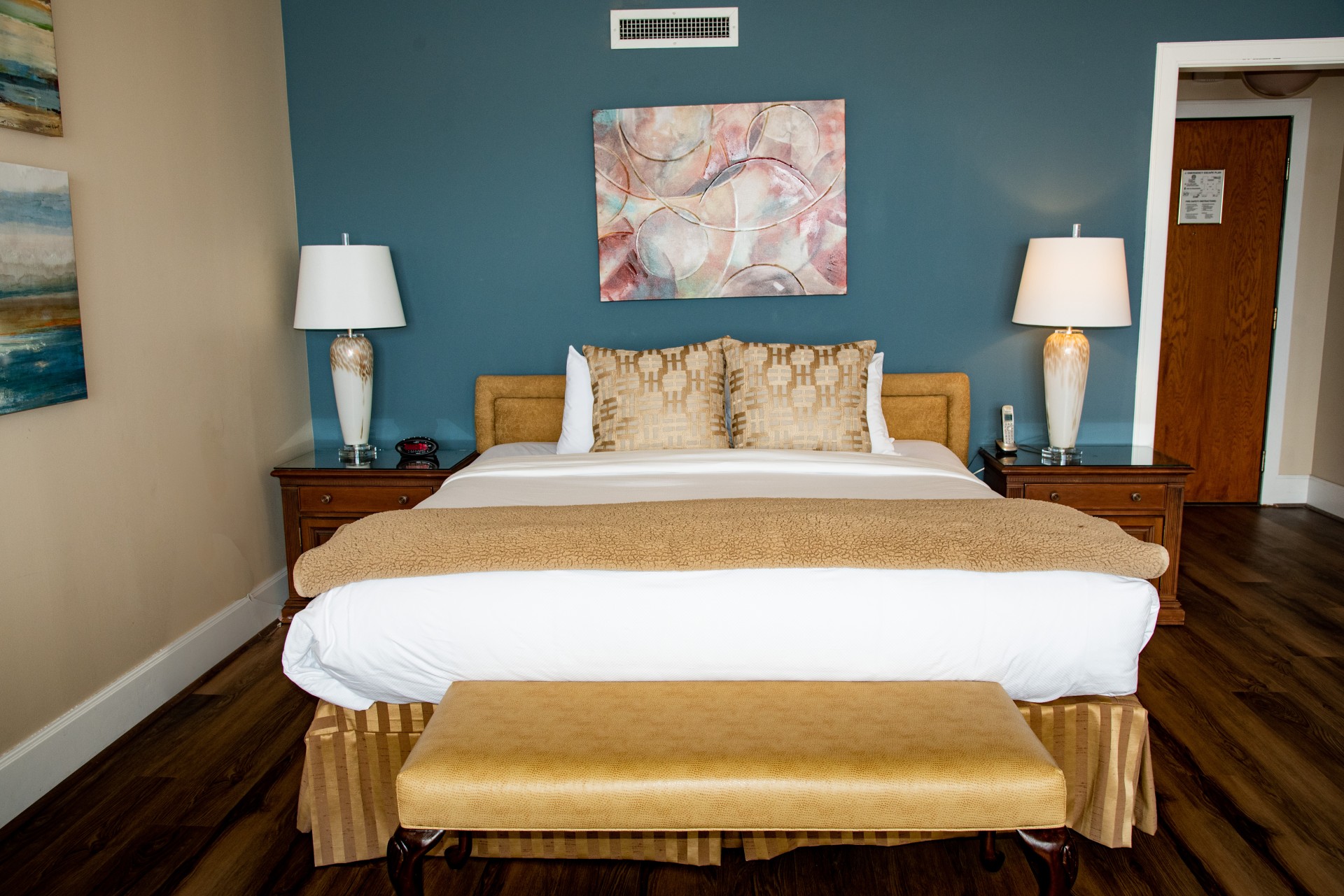 a bed with a bench and lamps