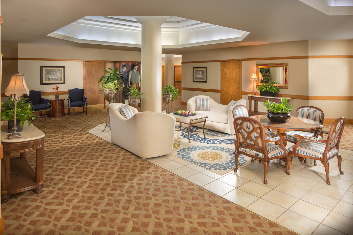 a room with a large white couch and a table