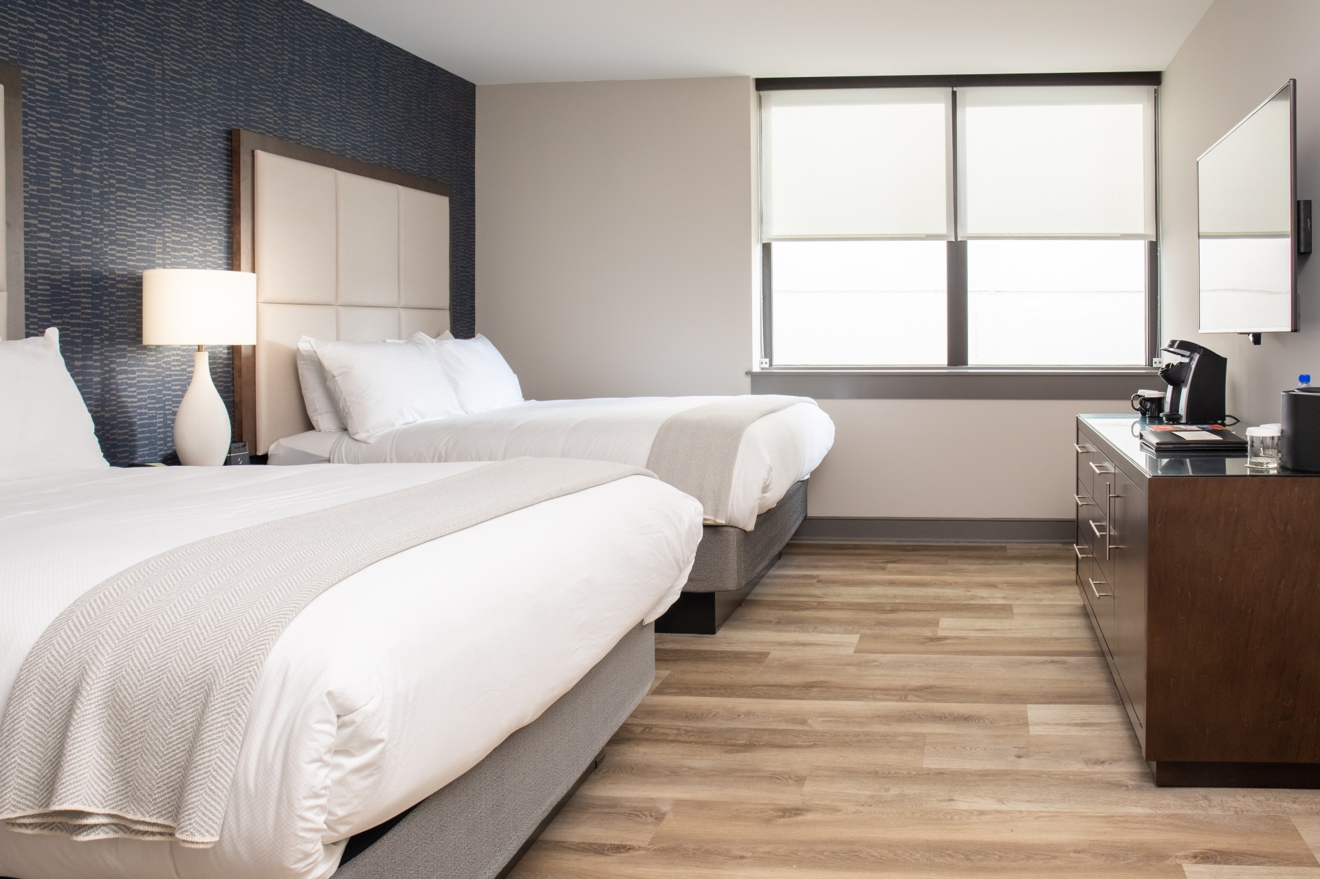 a room with two beds and a lamp