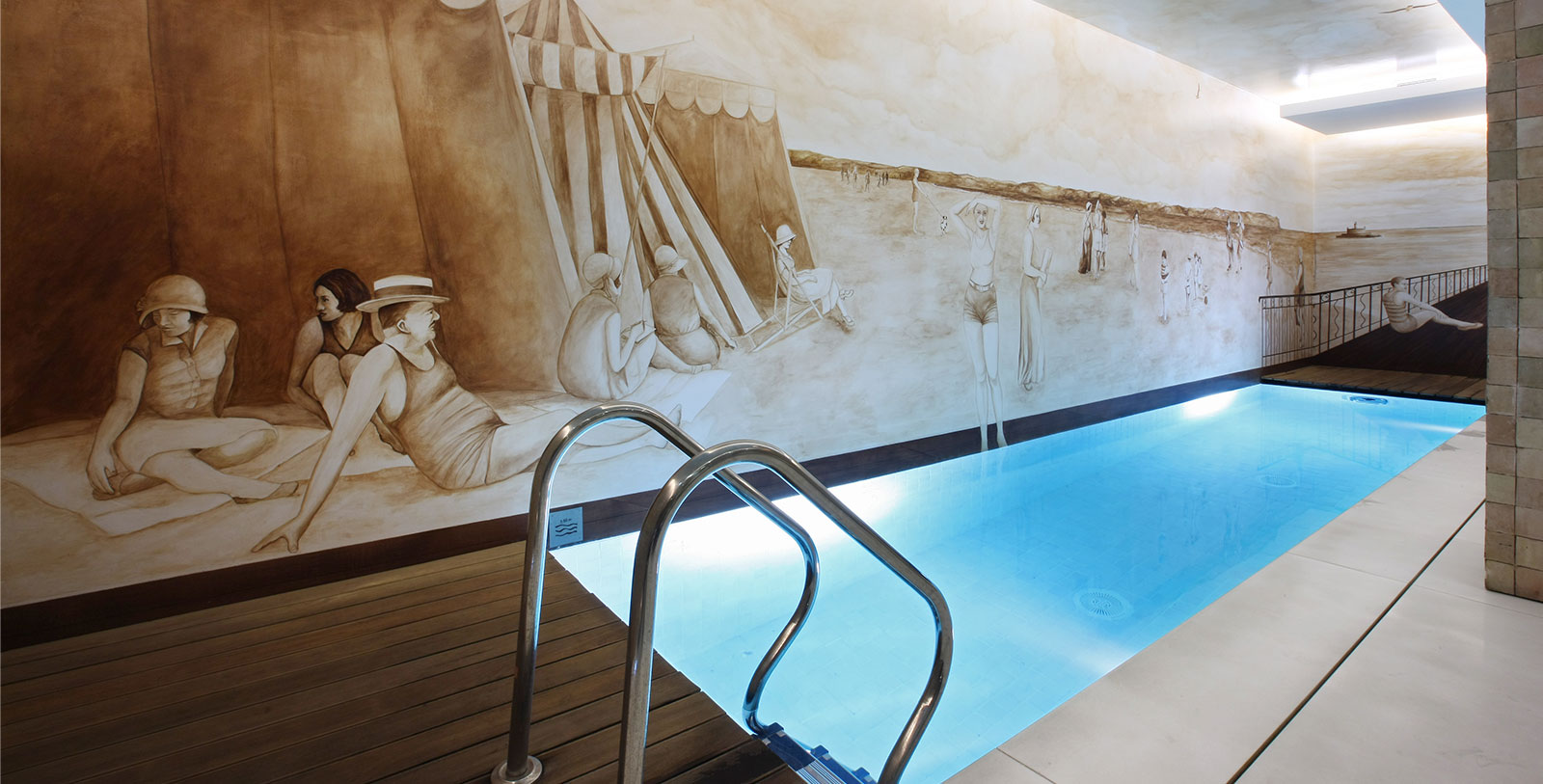 a swimming pool with a mural on the wall