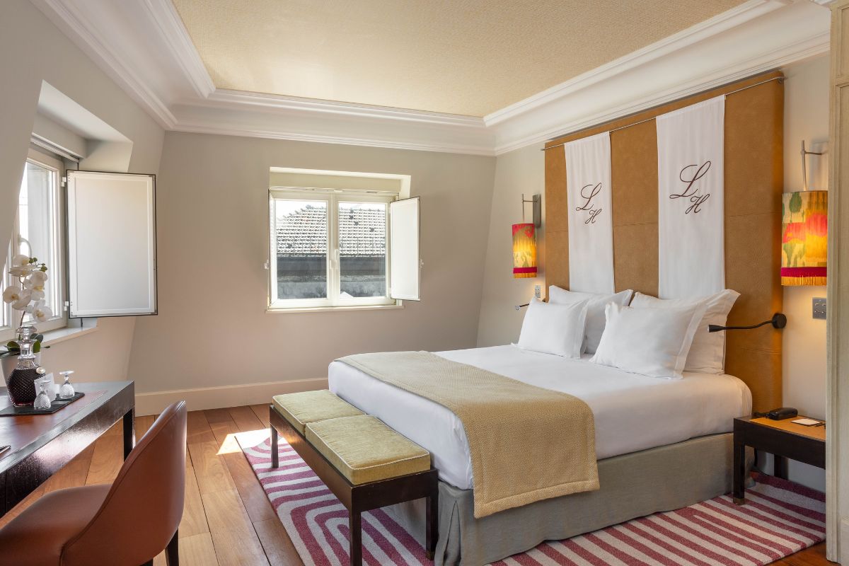 a bedroom with a bed and a bench