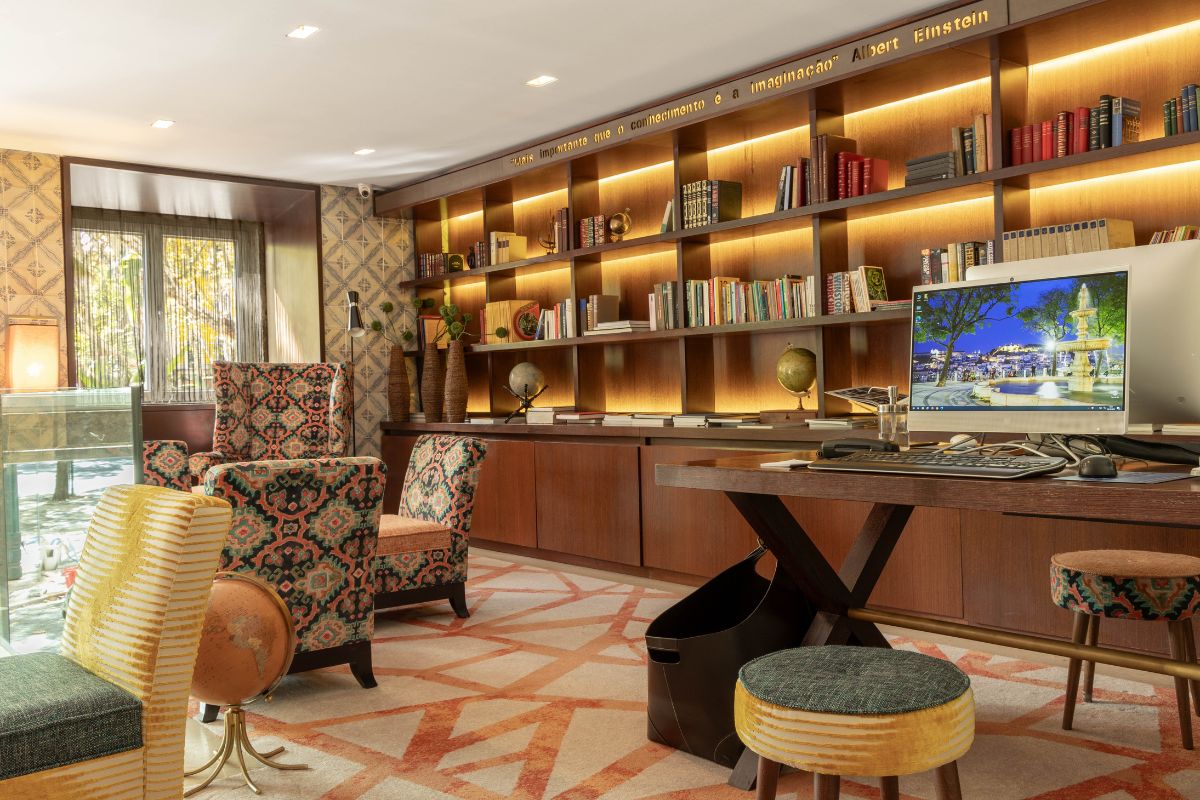 a room with a desk and bookshelves